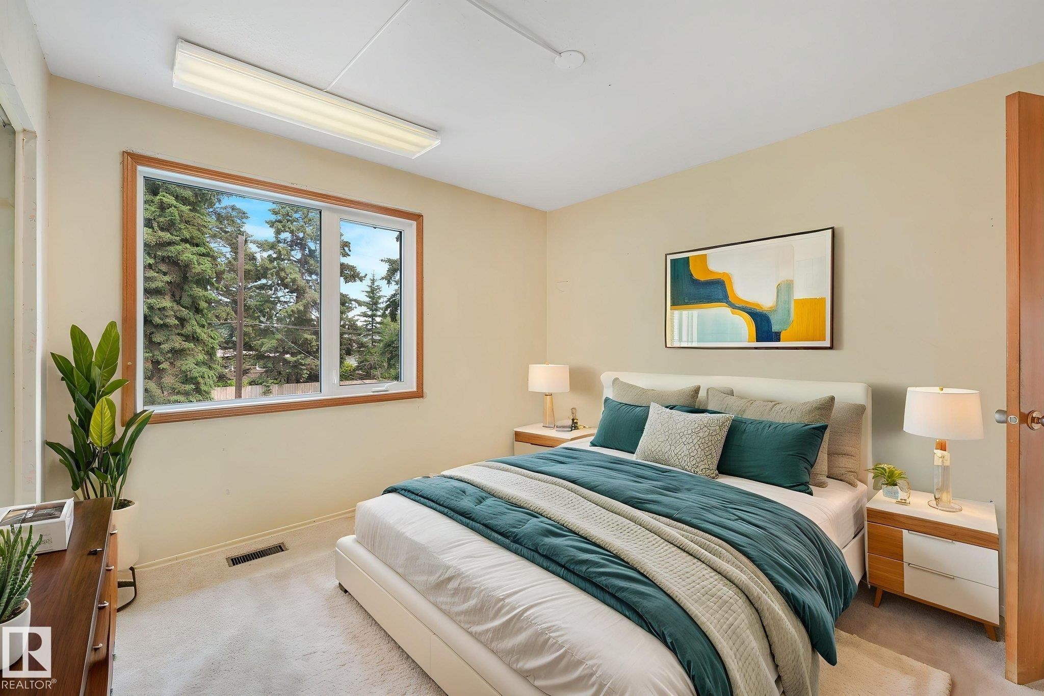 Carpeted room with a large window featuring a wood-finish frame - 13320 79 Avenue Nw, Edmonton, AB - Indoor Photo Showing Bedroom