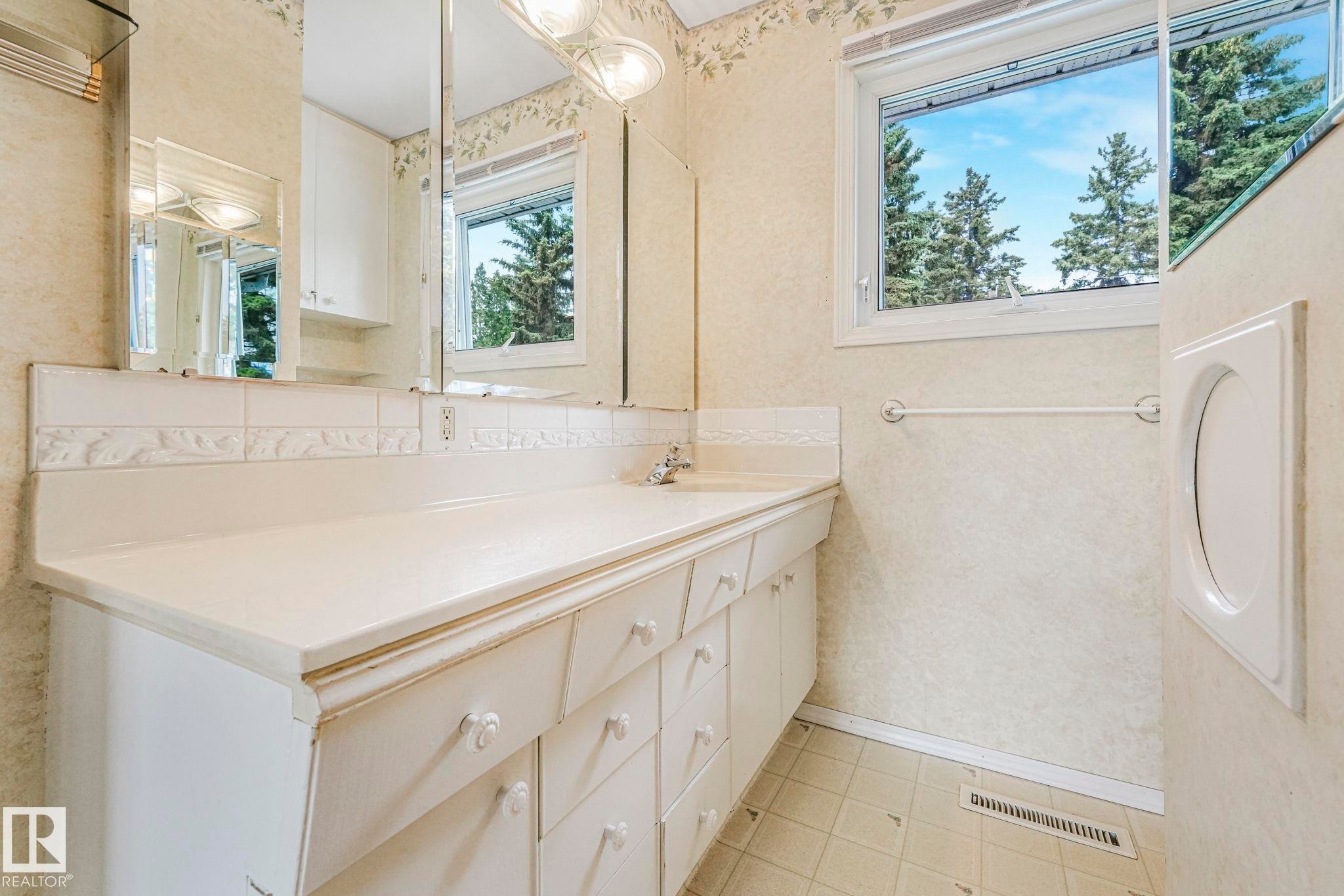 Vanity with ample counter space, featuring an integrated sink and multiple storage drawers - 13320 79 Avenue Nw, Edmonton, AB - Indoor Photo Showing Bathroom