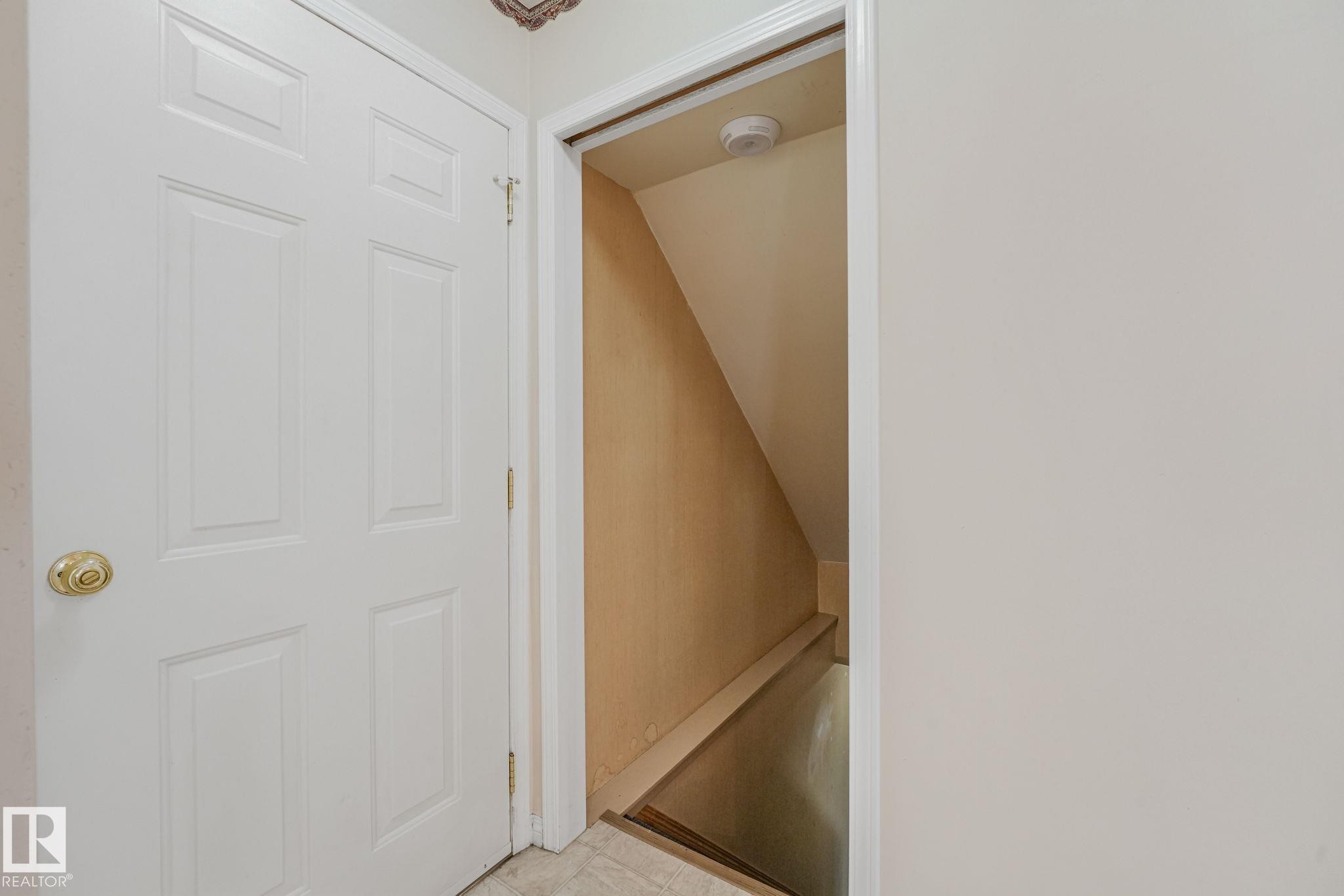 White paneled door with a brass knob - 13320 79 Avenue Nw, Edmonton, AB - Indoor Photo Showing Other Room