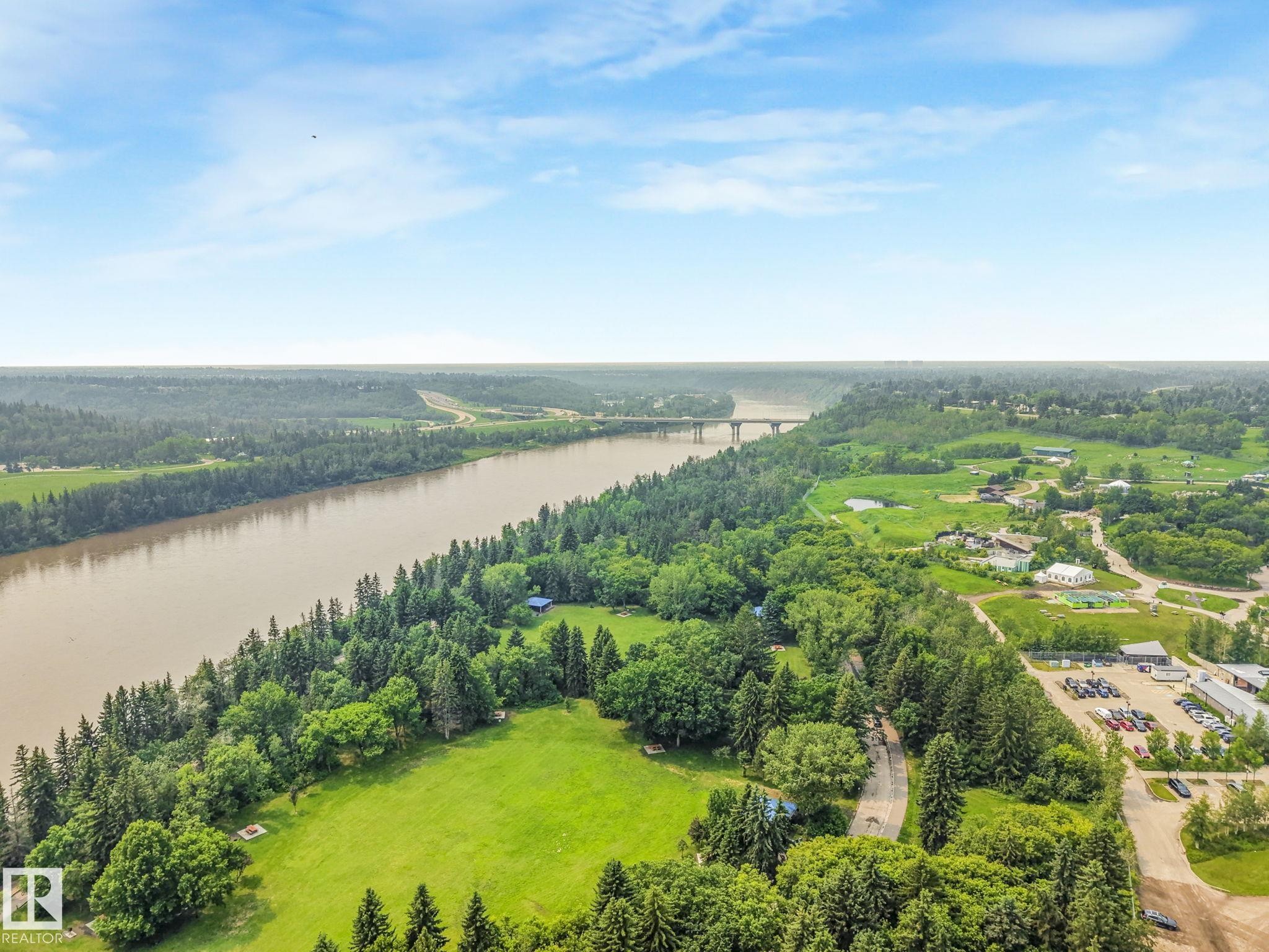 Expansive aerial perspective showcasing a river, a bridge, and surrounding green landscapes - 13320 79 Avenue Nw, Edmonton, AB - Outdoor With Body Of Water With View