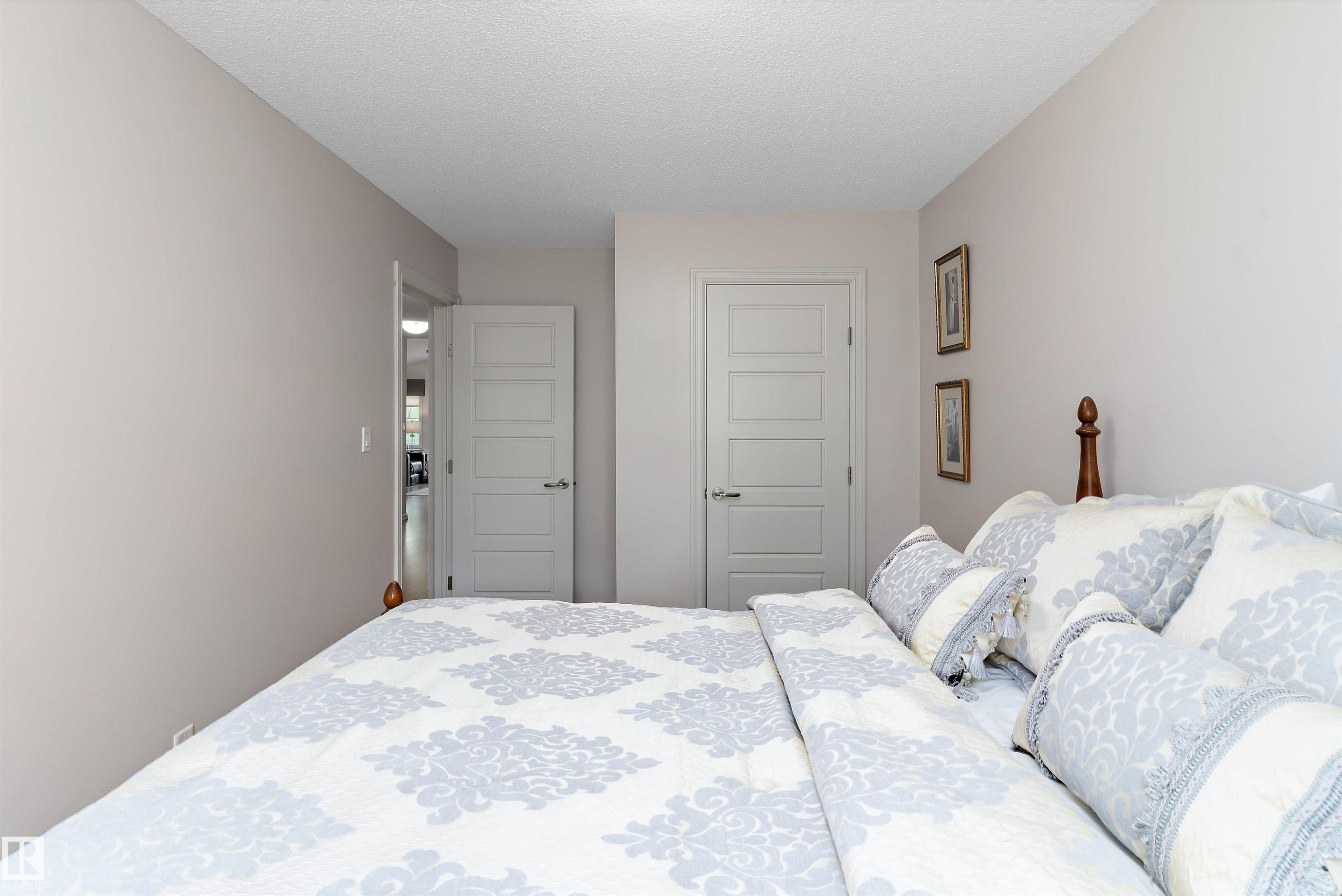 Interior space featuring two panel doors with contemporary hardware and a neutral color palette - 1097 Armitage Crescent, Edmonton, AB