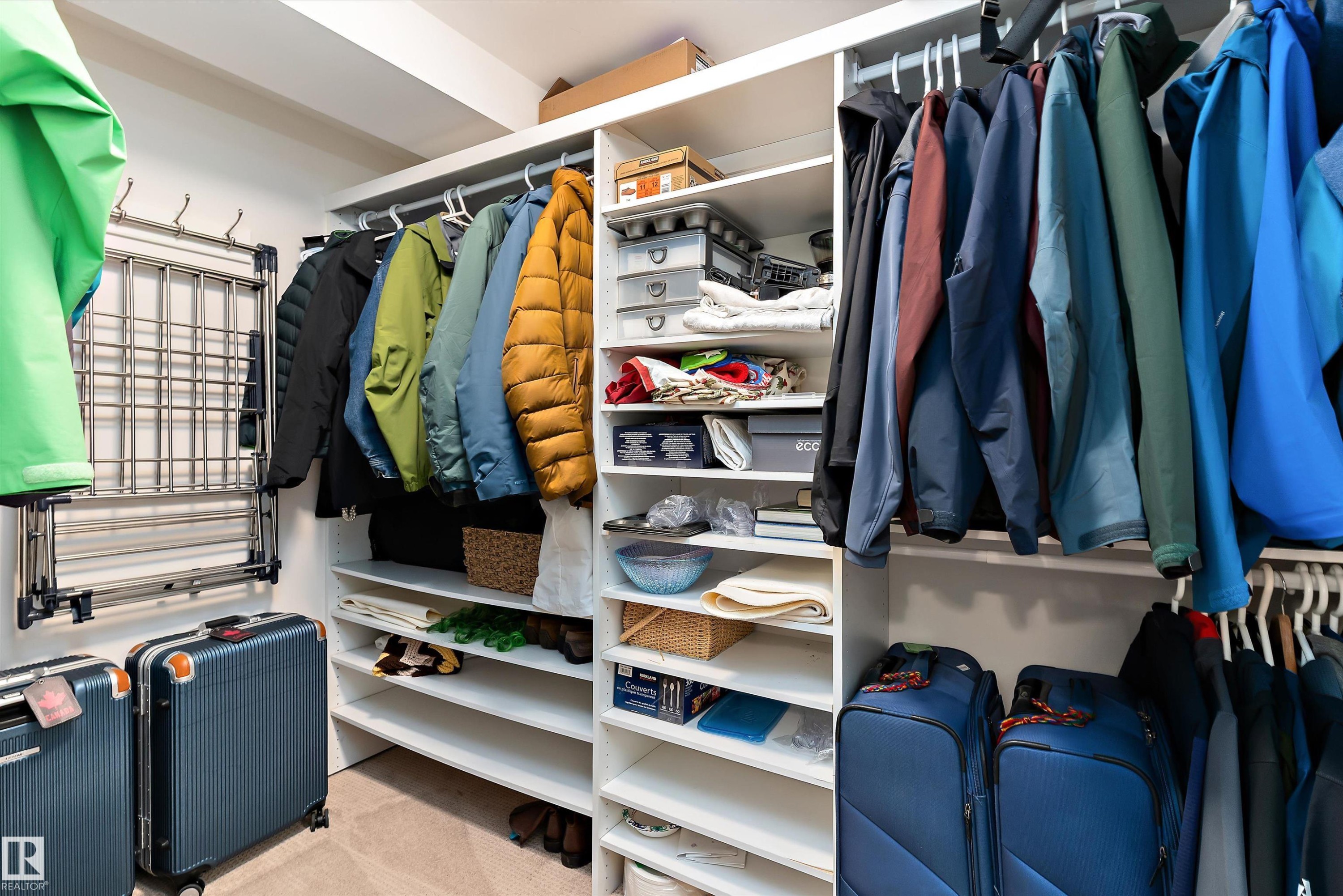 Custom closet system featuring multiple hanging rods and extensive shelving - 1097 Armitage Crescent, Edmonton, AB