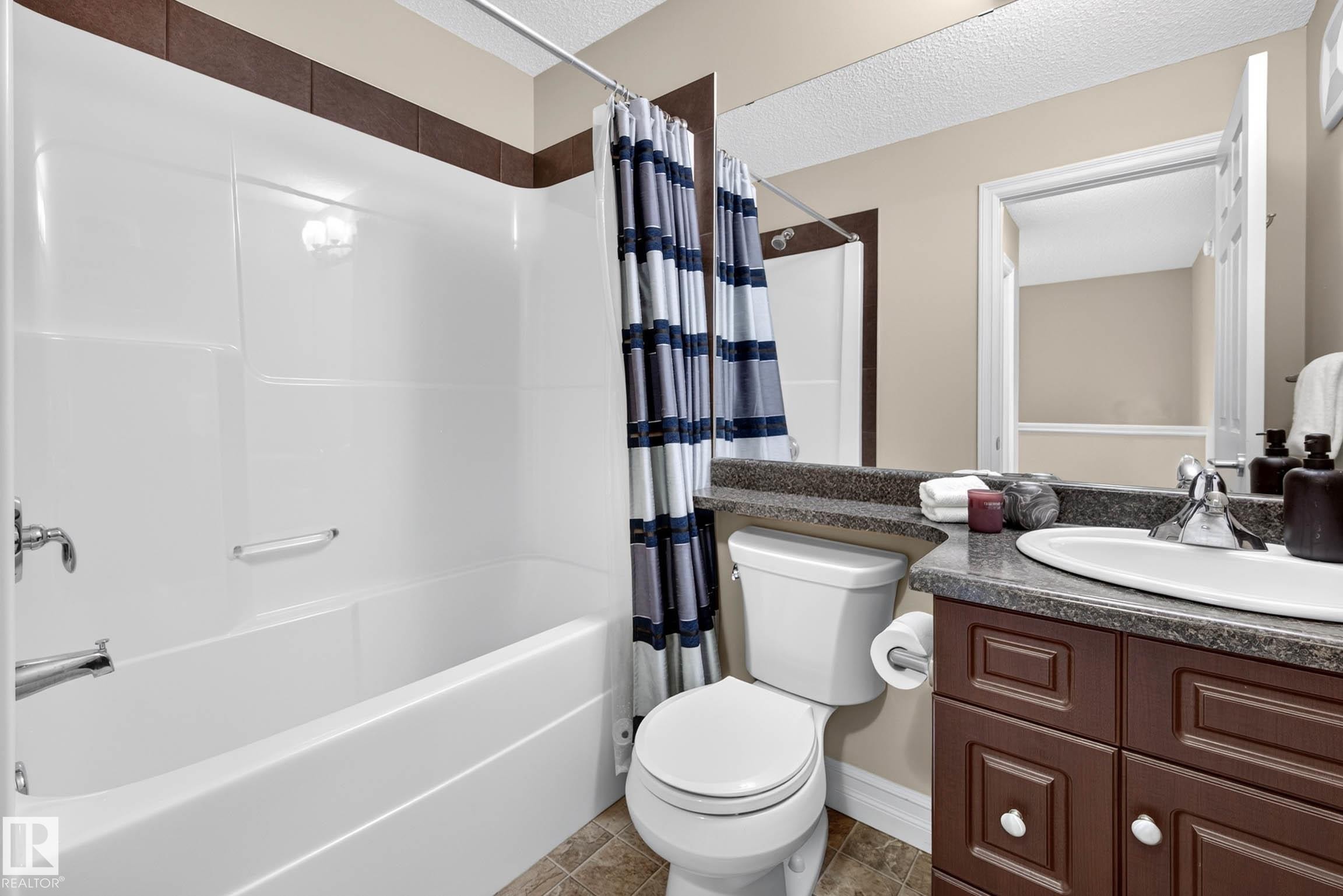White tub and shower combination with chrome fixtures - 12119 167A Avenue, Edmonton, AB