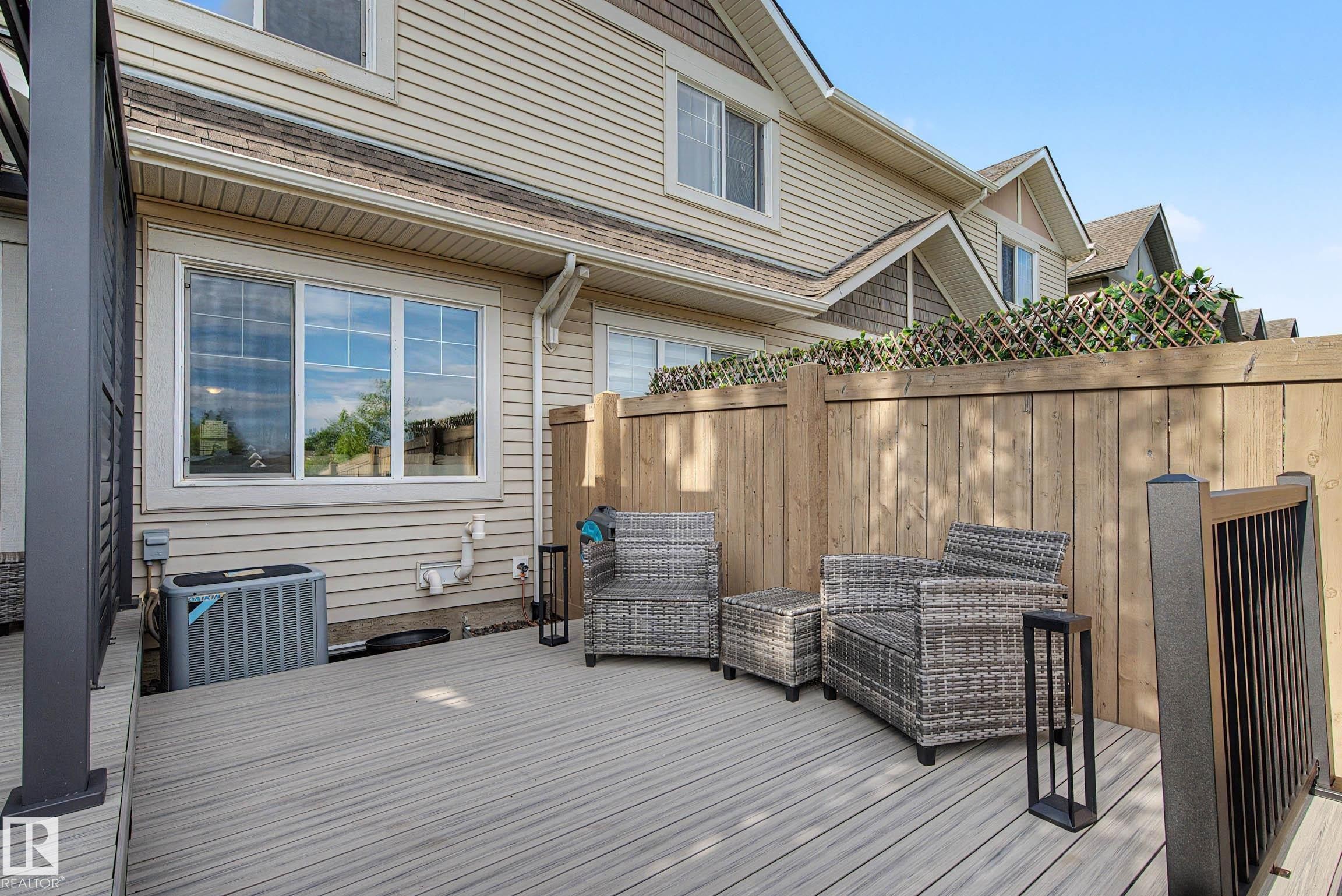 Spacious outdoor deck featuring composite decking and dark gray railing - 12119 167A Avenue, Edmonton, AB