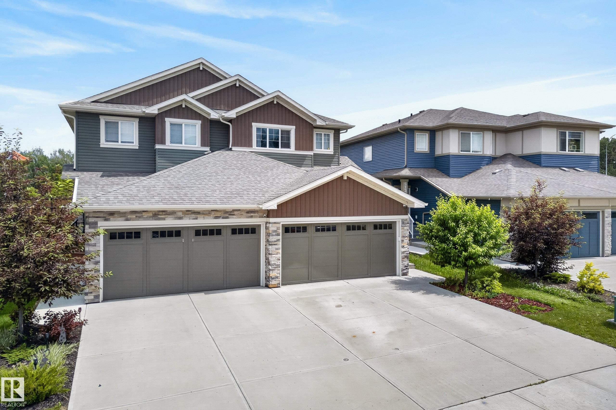 Multi-story residence featuring composite siding, stone veneer accents, and a multi-gabled roofline - 5129 Lark Crescent Nw, Edmonton, AB - Outdoor With Facade