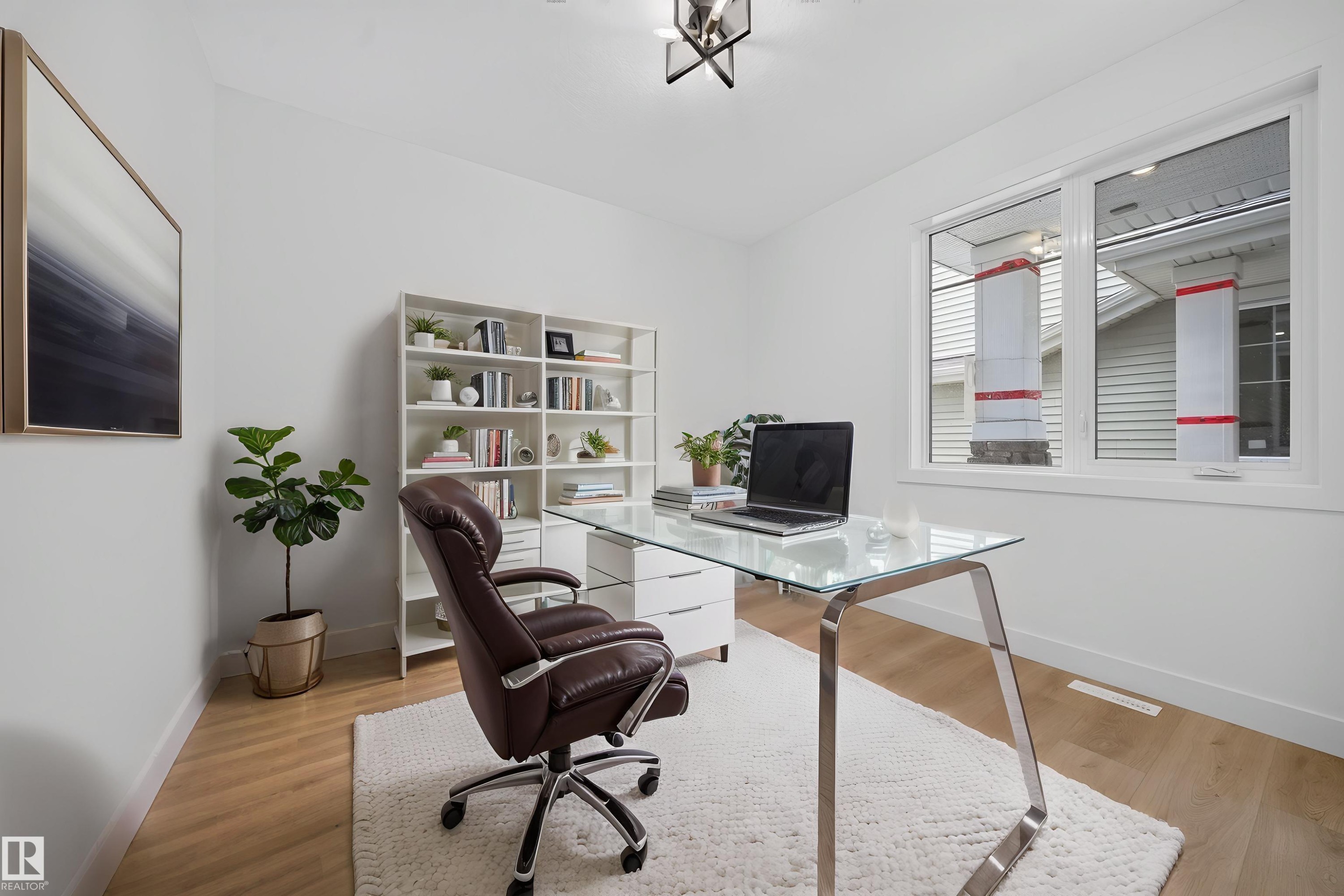 Entryway mudroom featuring built-in white shelving, integrated bench seating, and five black coat hooks - 803 30 Avenue, Edmonton, AB