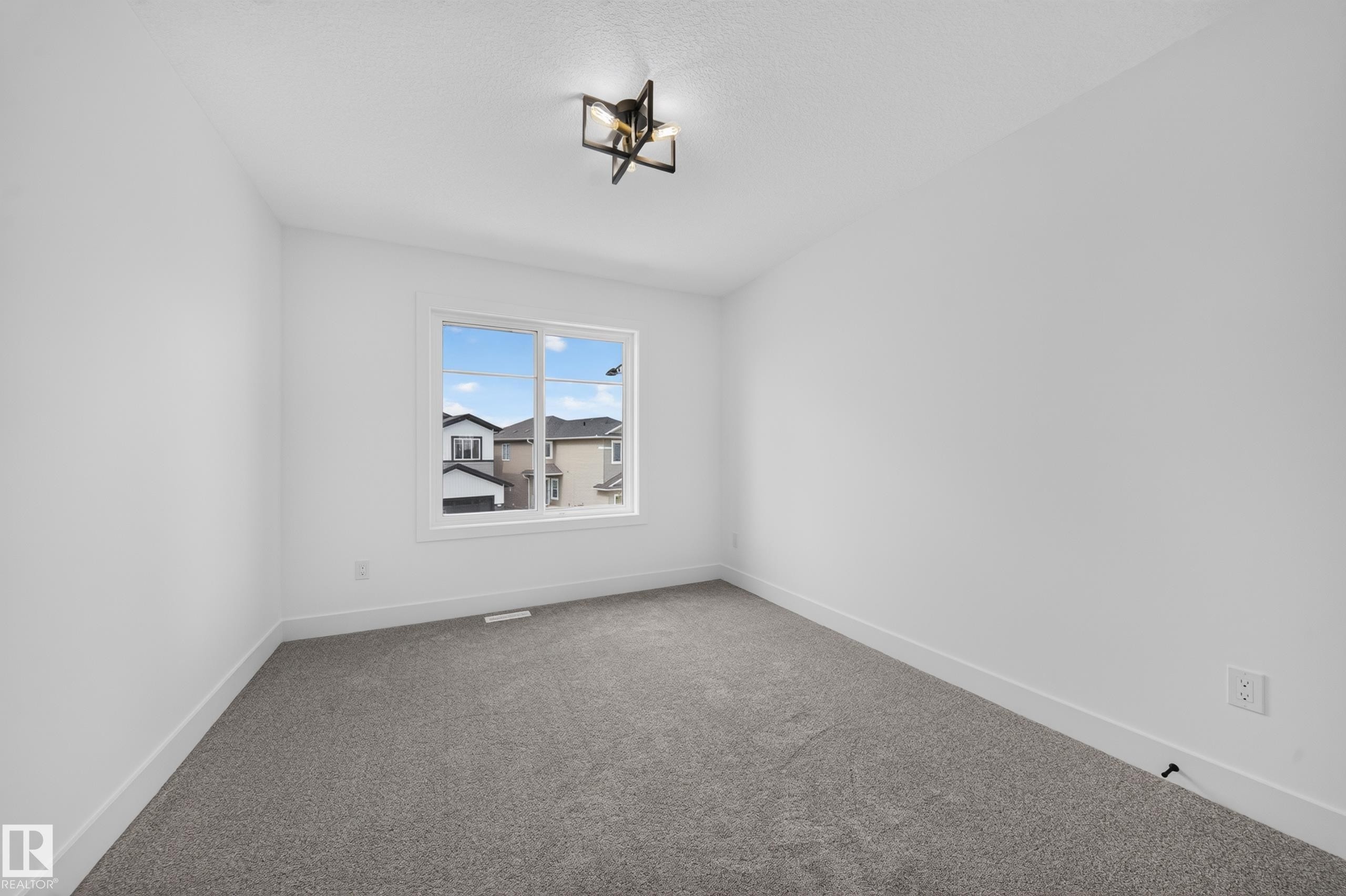 Walk-in closet featuring built-in shelving, hanging rods, light gray carpeting, crisp white walls, and white trim - 803 30 Avenue, Edmonton, AB