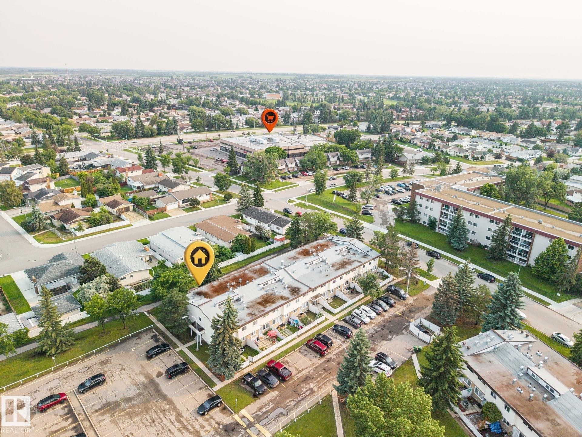Aerial view showcasing a multi-unit residential property with surface parking - 105 16428 109 Street, Edmonton, AB