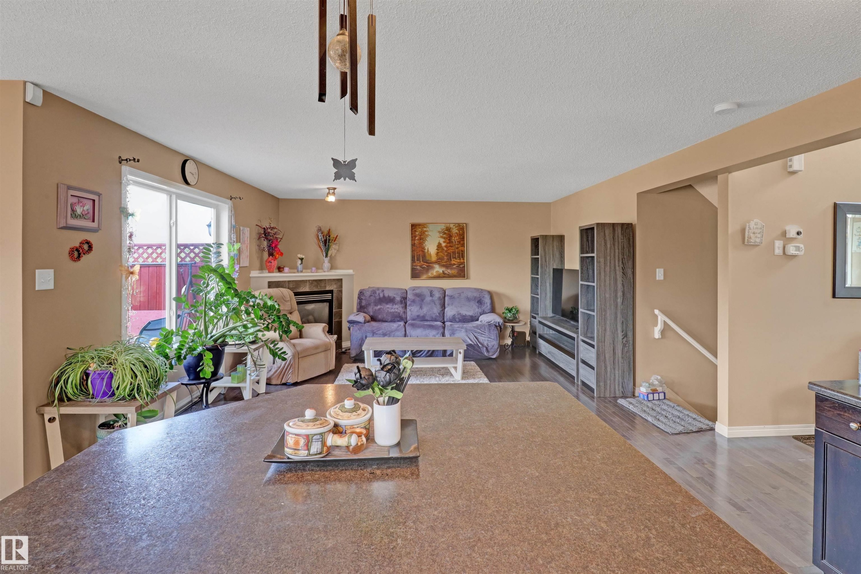 Open-concept living space with a large kitchen island featuring a speckled countertop - 1216 37C Avenue Nw, Edmonton, AB - Indoor Photo Showing Living Room
