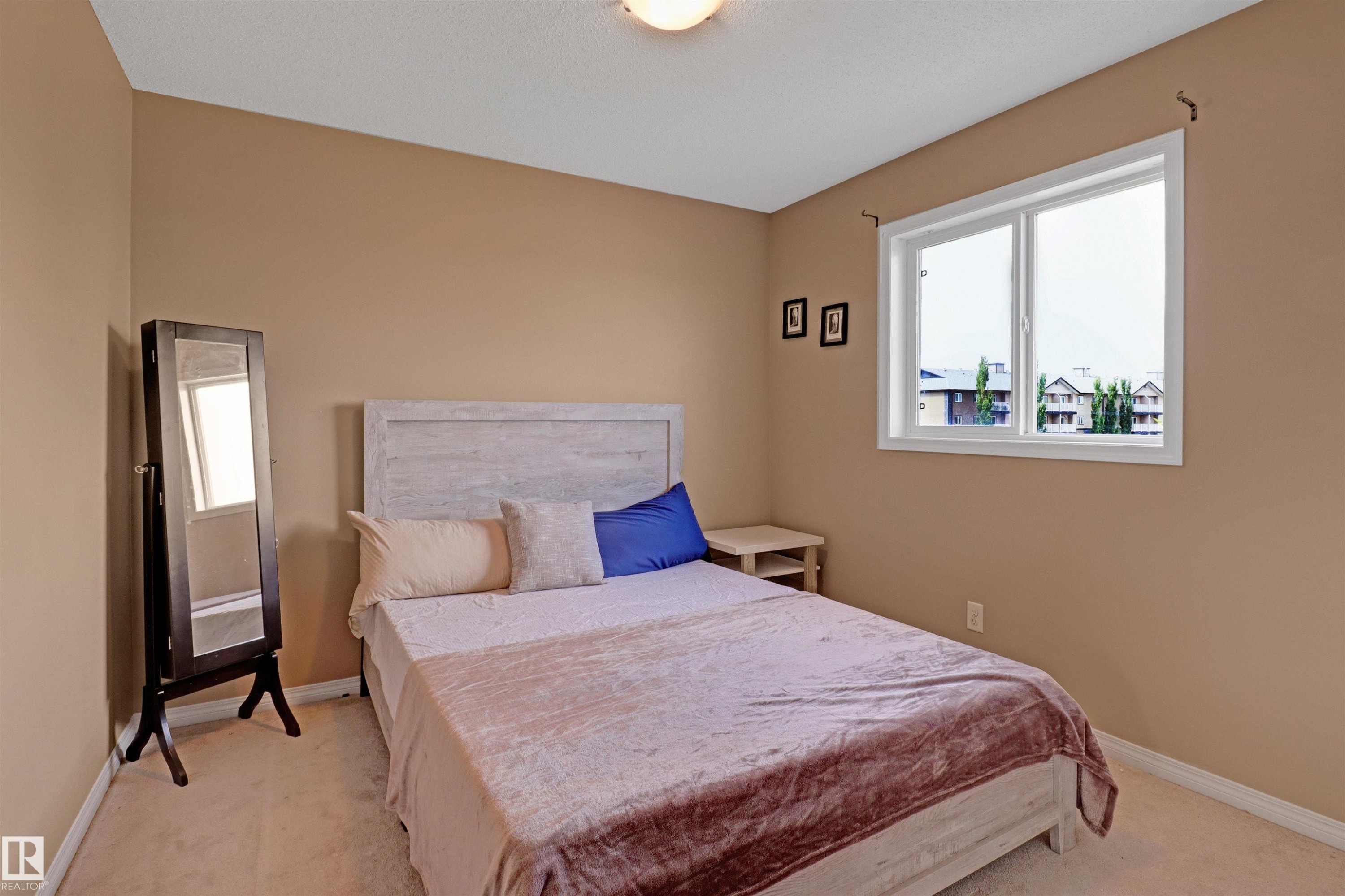 Carpeted bedroom with a single window featuring white trim - 1216 37C Avenue Nw, Edmonton, AB - Indoor Photo Showing Bedroom