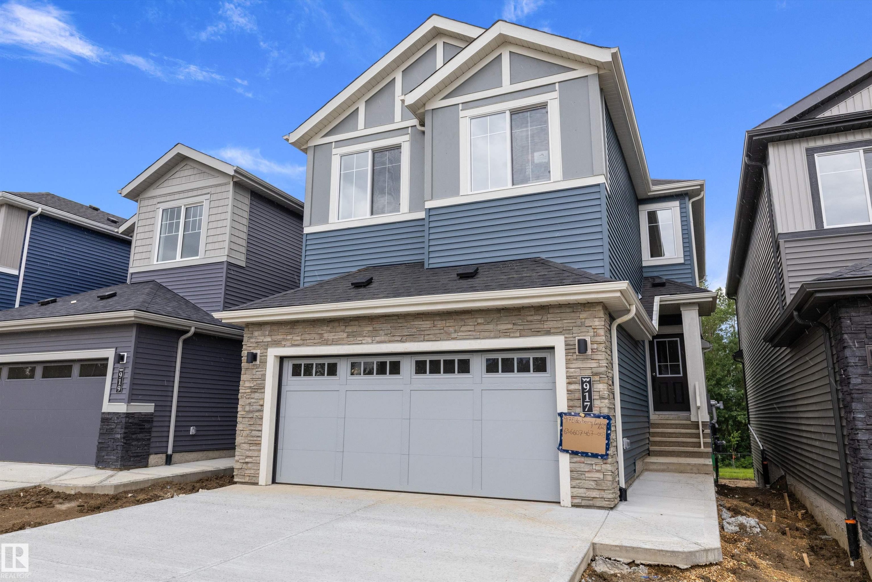 Modern two-story residence featuring a stone and siding facade - 917 Elderberry Landing, Edmonton, AB