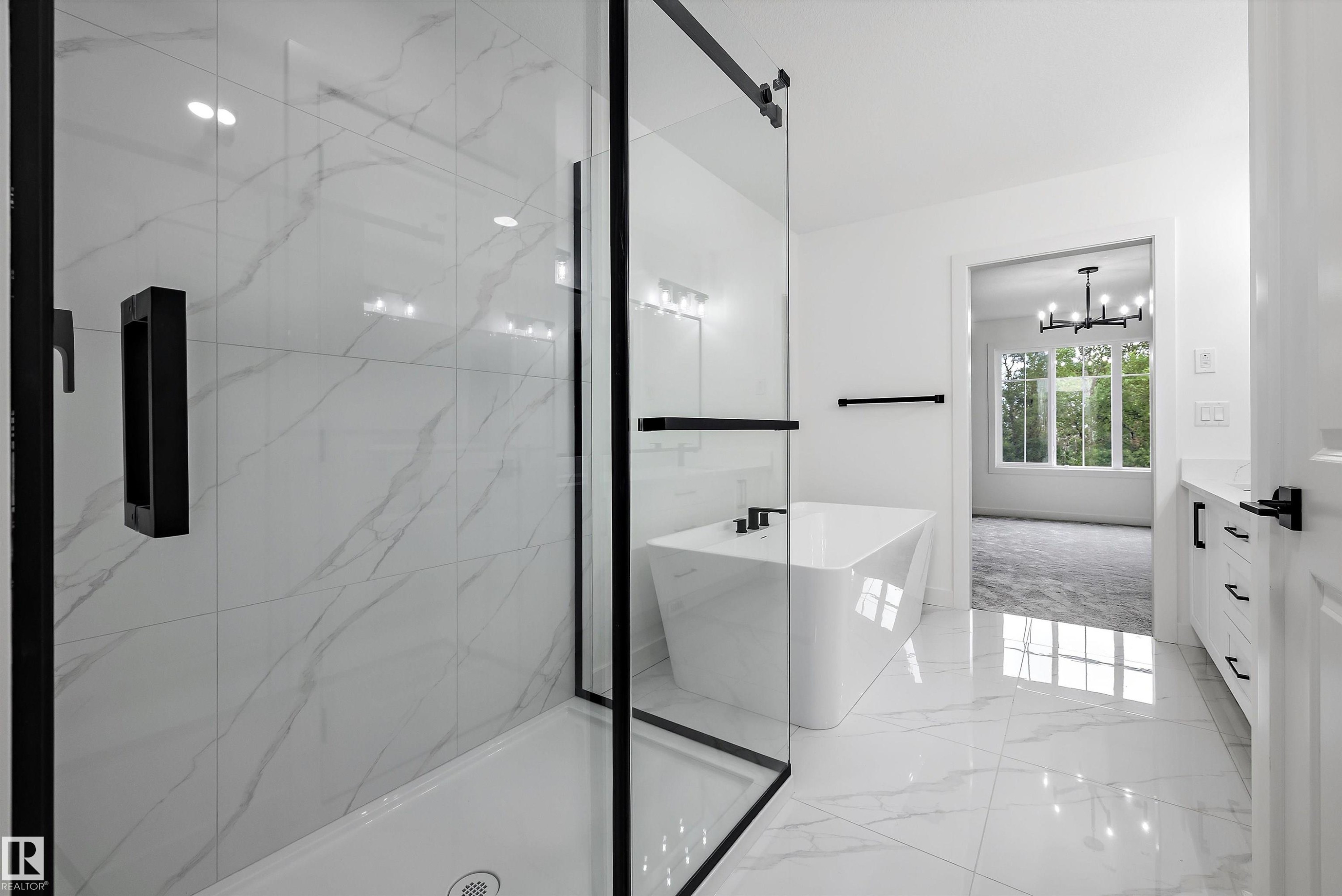 Contemporary bathroom featuring a spacious glass-enclosed shower with black trim, a standalone soaking tub, and marble-look tile flooring - 917 Elderberry Landing, Edmonton, AB