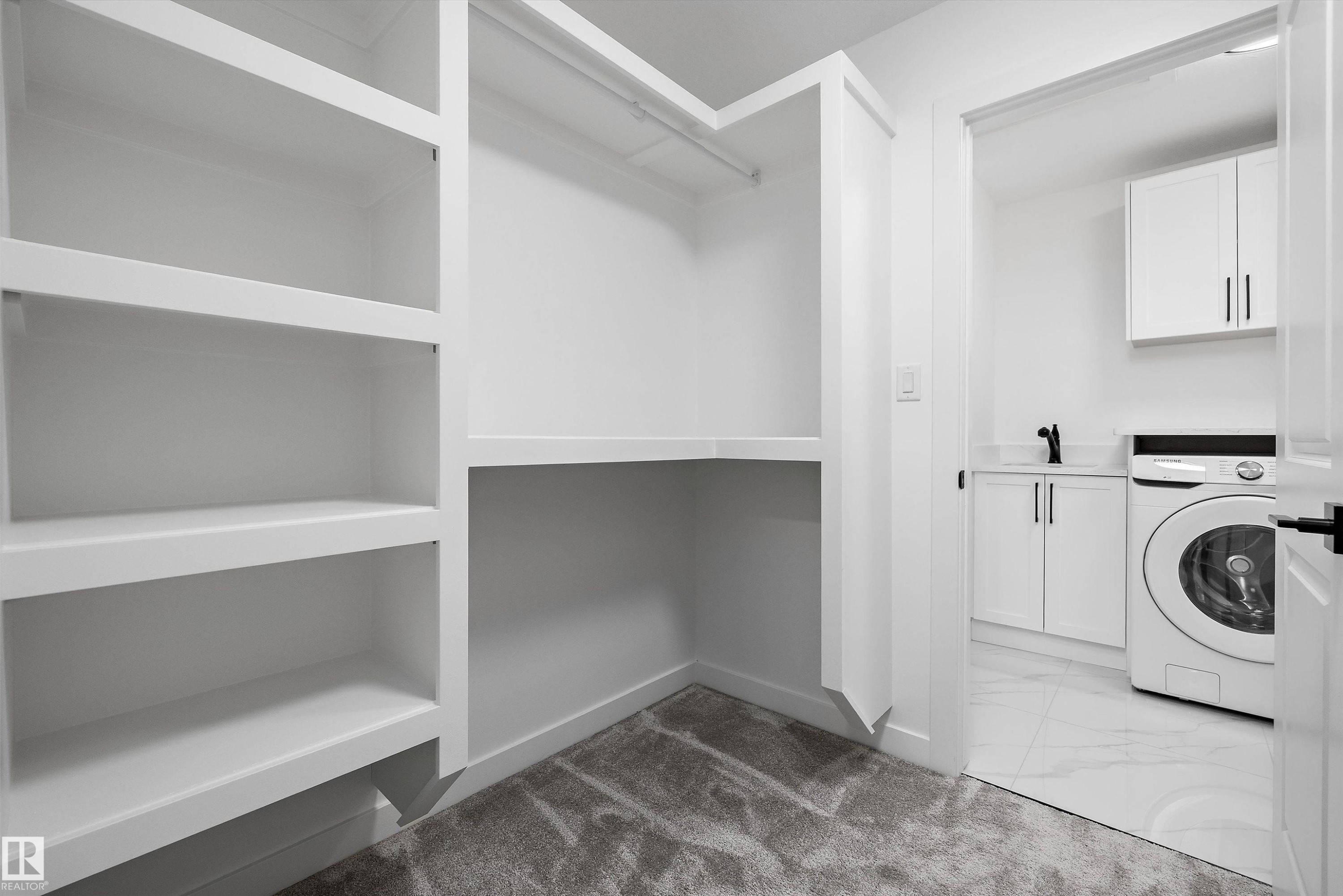 Custom built-in white shelving and hanging rod with grey carpet flooring - 917 Elderberry Landing, Edmonton, AB