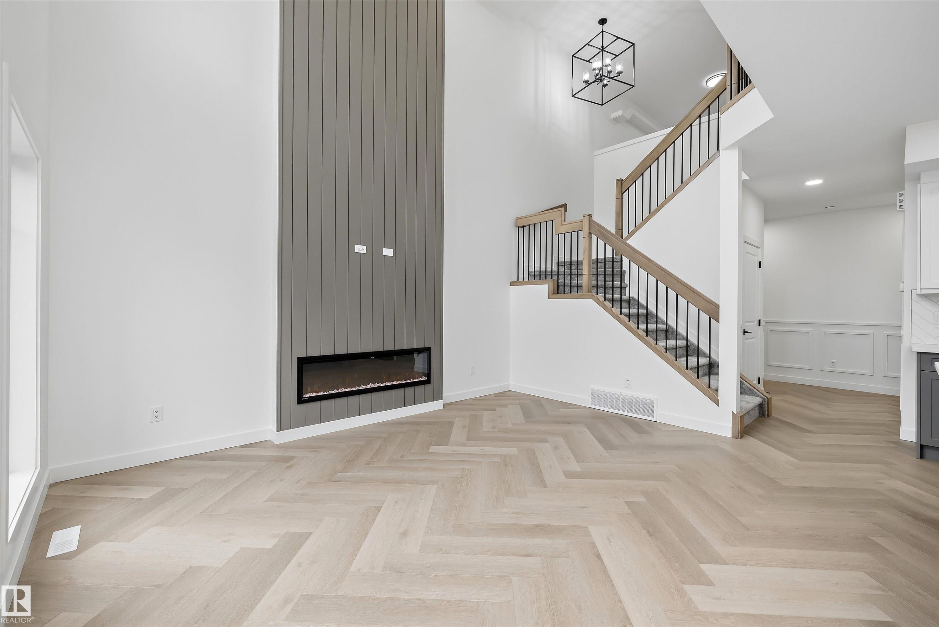 Herringbone wood-finish flooring extending through the space - 917 Elderberry Landing, Edmonton, AB