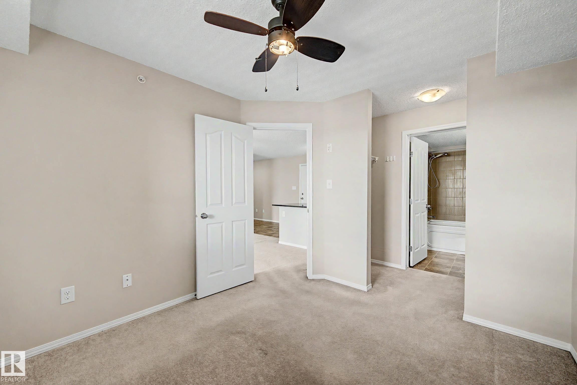 Neutral-toned carpeting throughout - 404 1080 Mcconachie Boulevard, Edmonton, AB