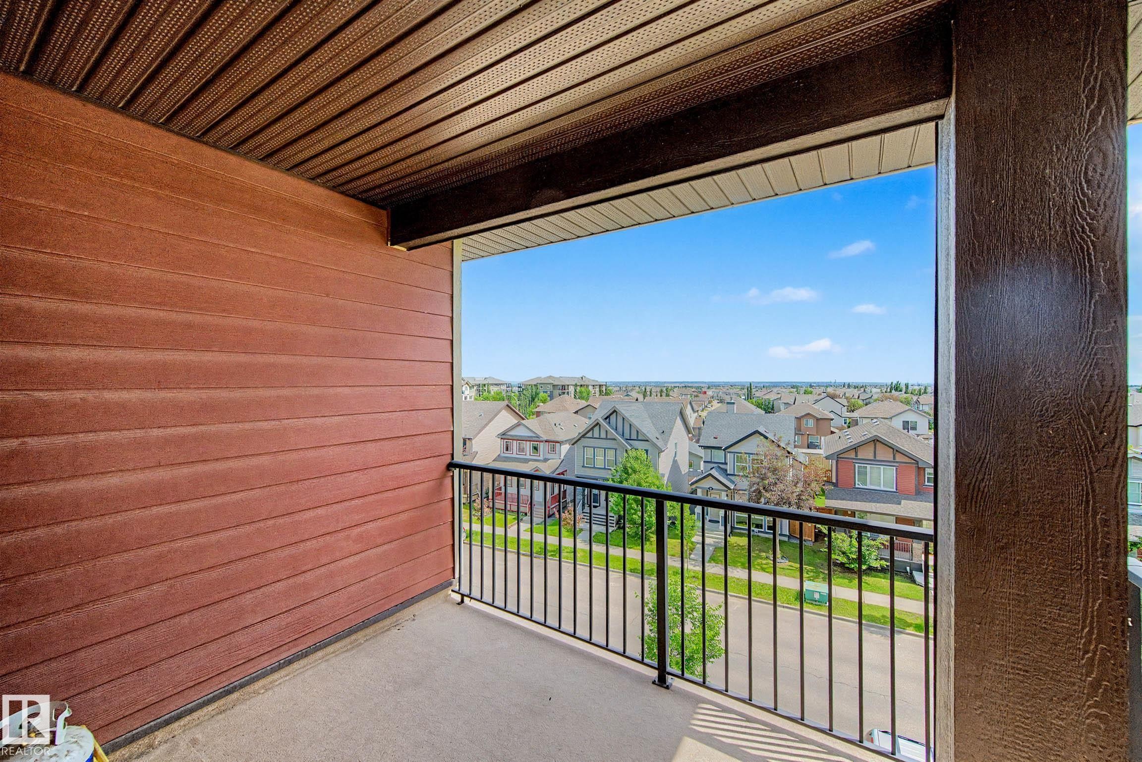 Outdoor balcony featuring a metal railing and concrete flooring - 404 1080 Mcconachie Boulevard, Edmonton, AB