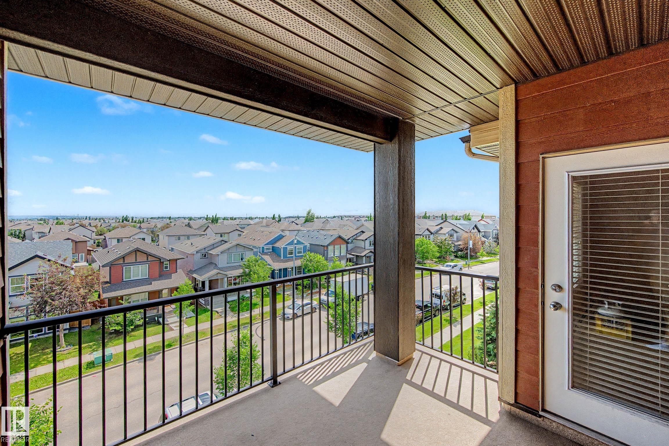 Spacious private balcony with concrete flooring and black metal railings - 404 1080 Mcconachie Boulevard, Edmonton, AB