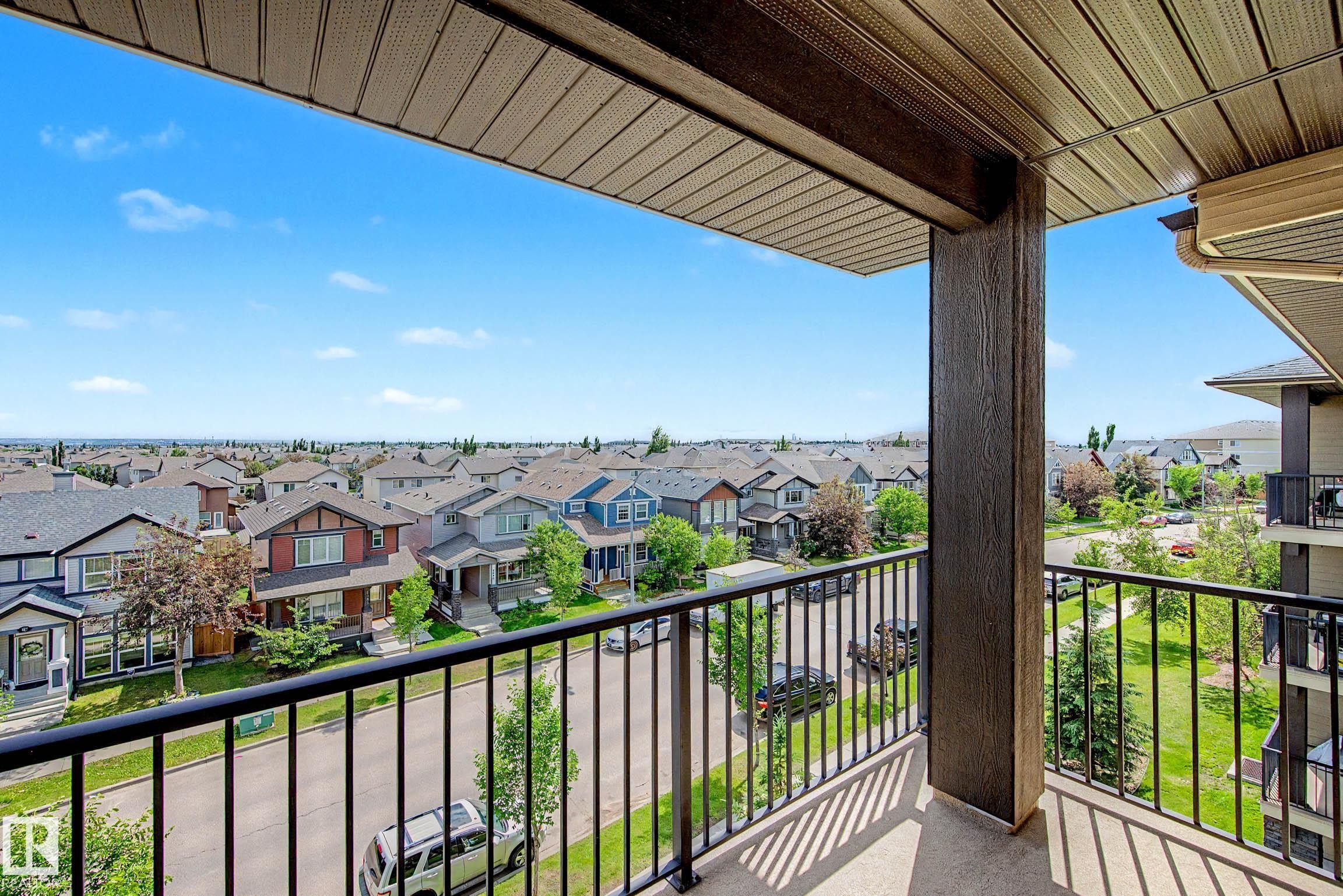 Private balcony with concrete flooring and black metal railing - 404 1080 Mcconachie Boulevard, Edmonton, AB