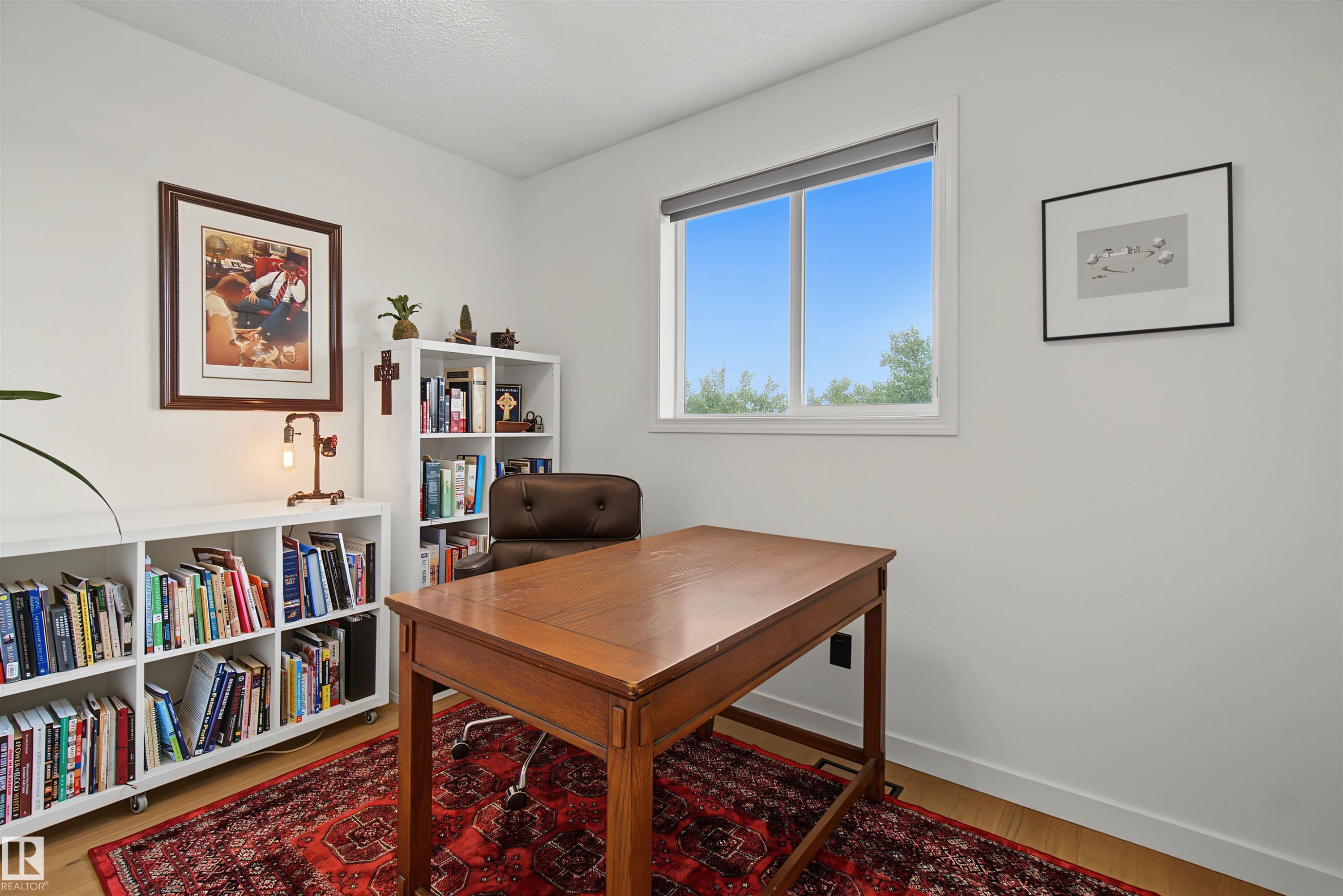Bright room featuring light wood-finish flooring and white walls - 15 450 Hyndman Crescent, Edmonton, AB