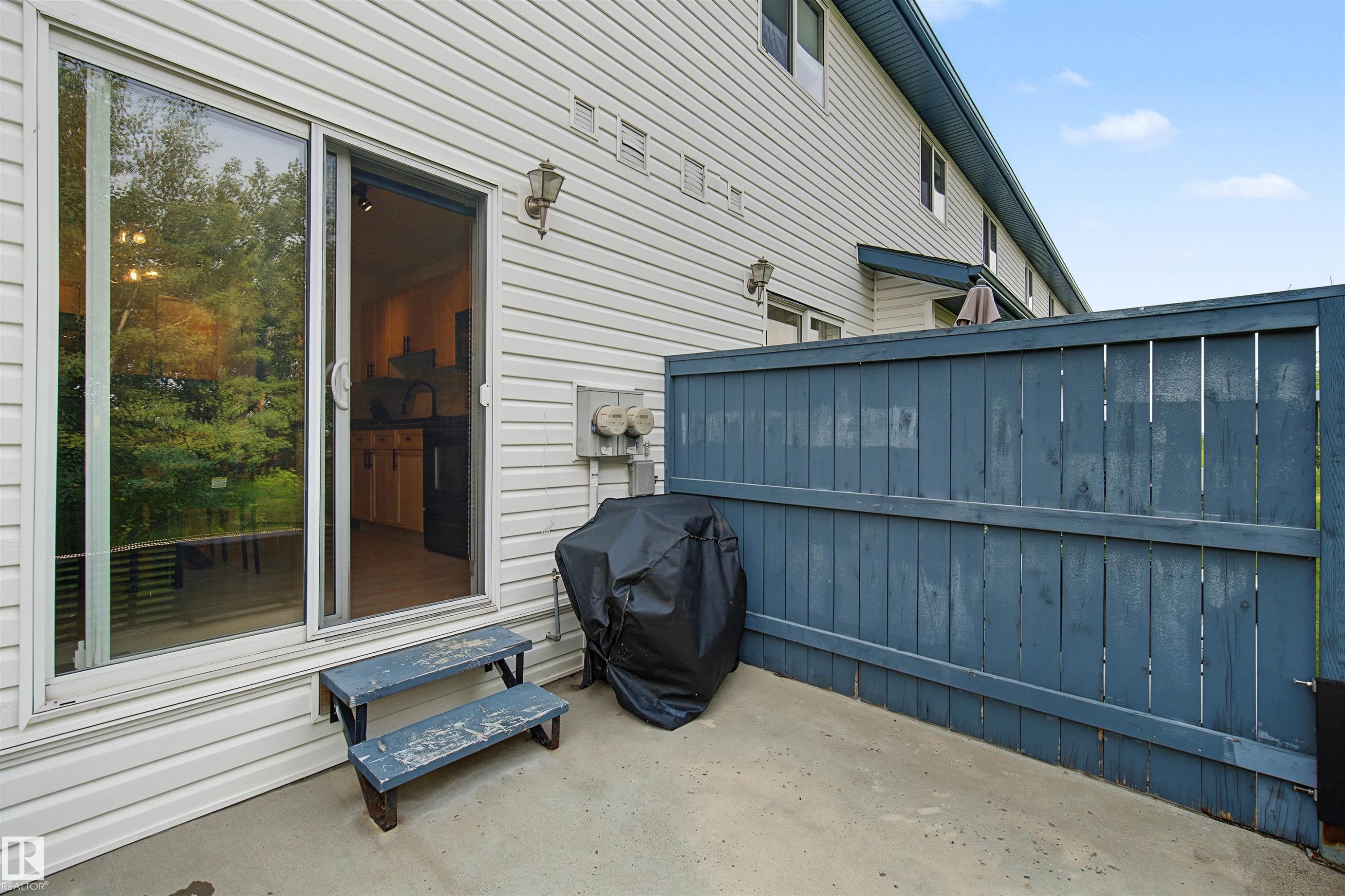 Paved patio area featuring privacy fencing - 15 450 Hyndman Crescent, Edmonton, AB
