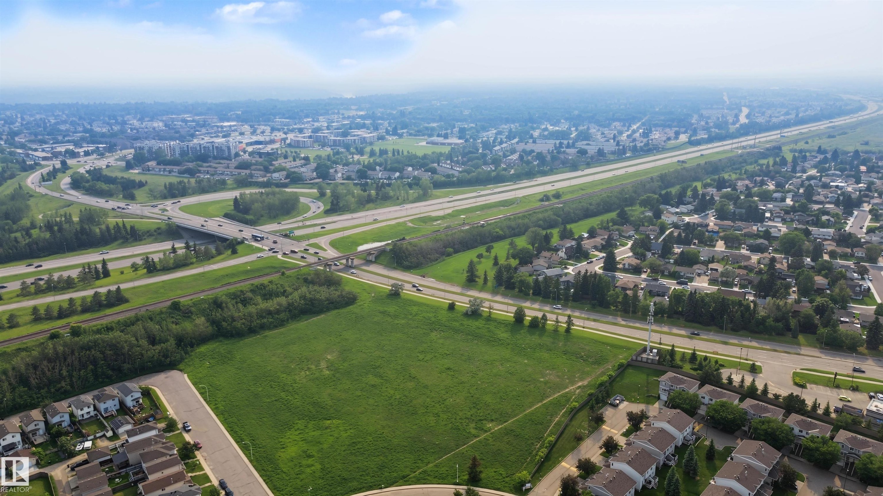 Expansive land parcel featuring a green field - 15 450 Hyndman Crescent, Edmonton, AB