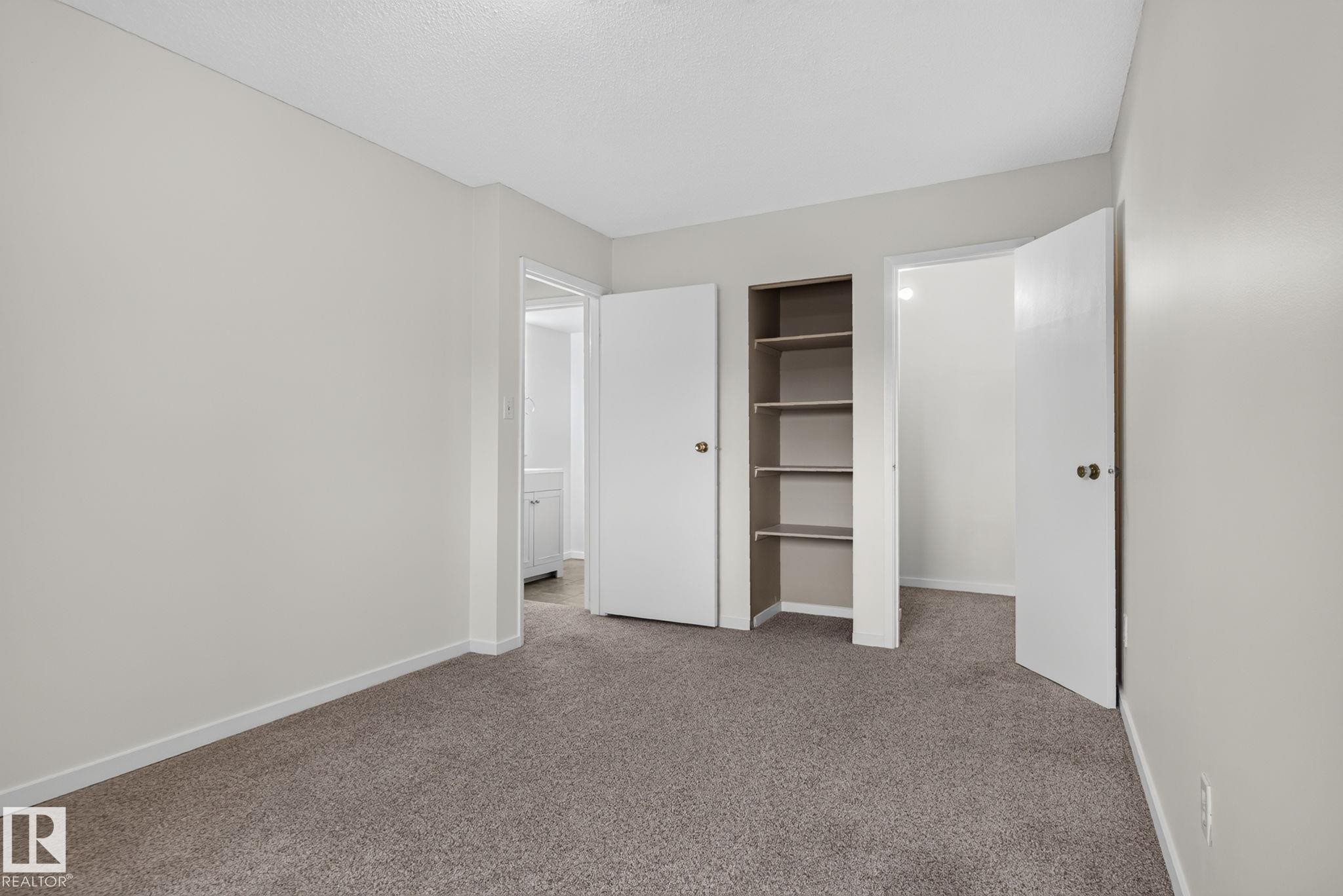 Interior room featuring light gray walls, plush gray carpeting, and white trim - 401 2908 116A Avenue, Edmonton, AB