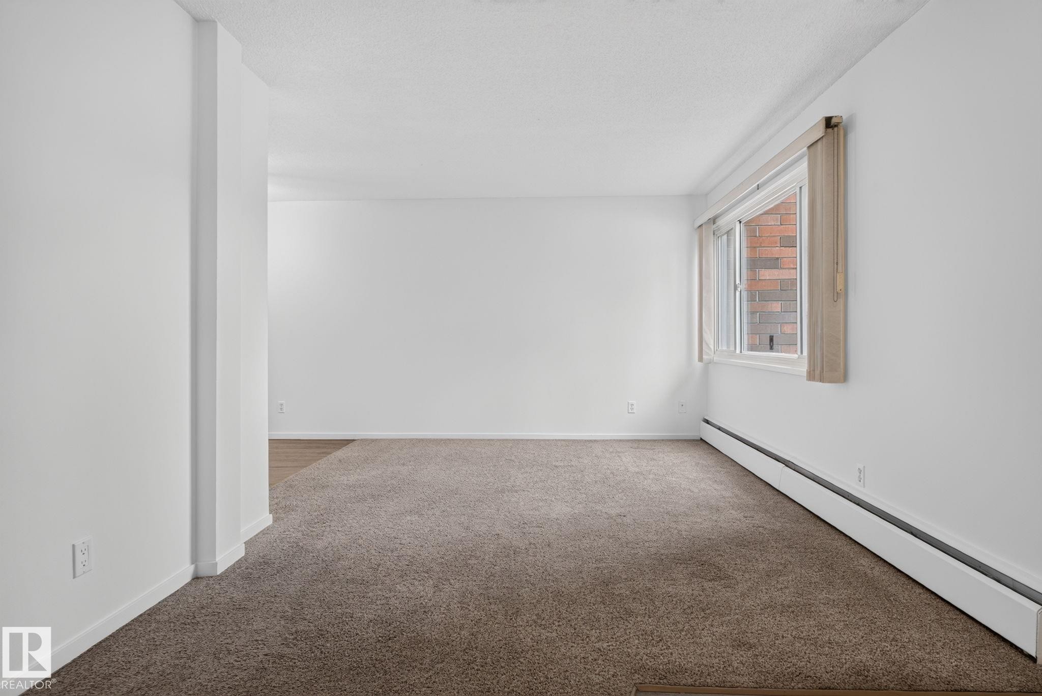 Carpeted living space with white walls and baseboard trim - 401 2908 116A Avenue, Edmonton, AB