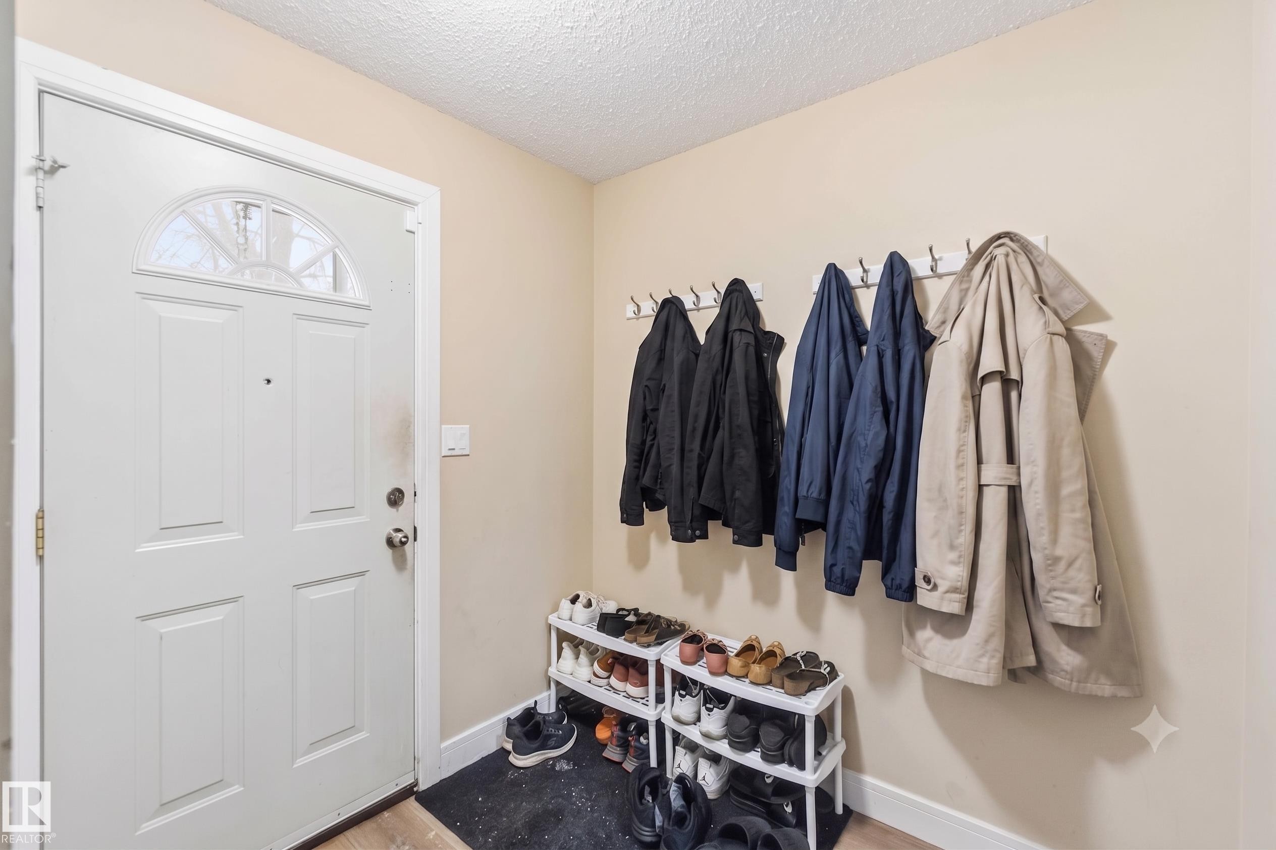Entryway featuring a paneled door with an arched transom window - 17118 108 Street, Edmonton, AB