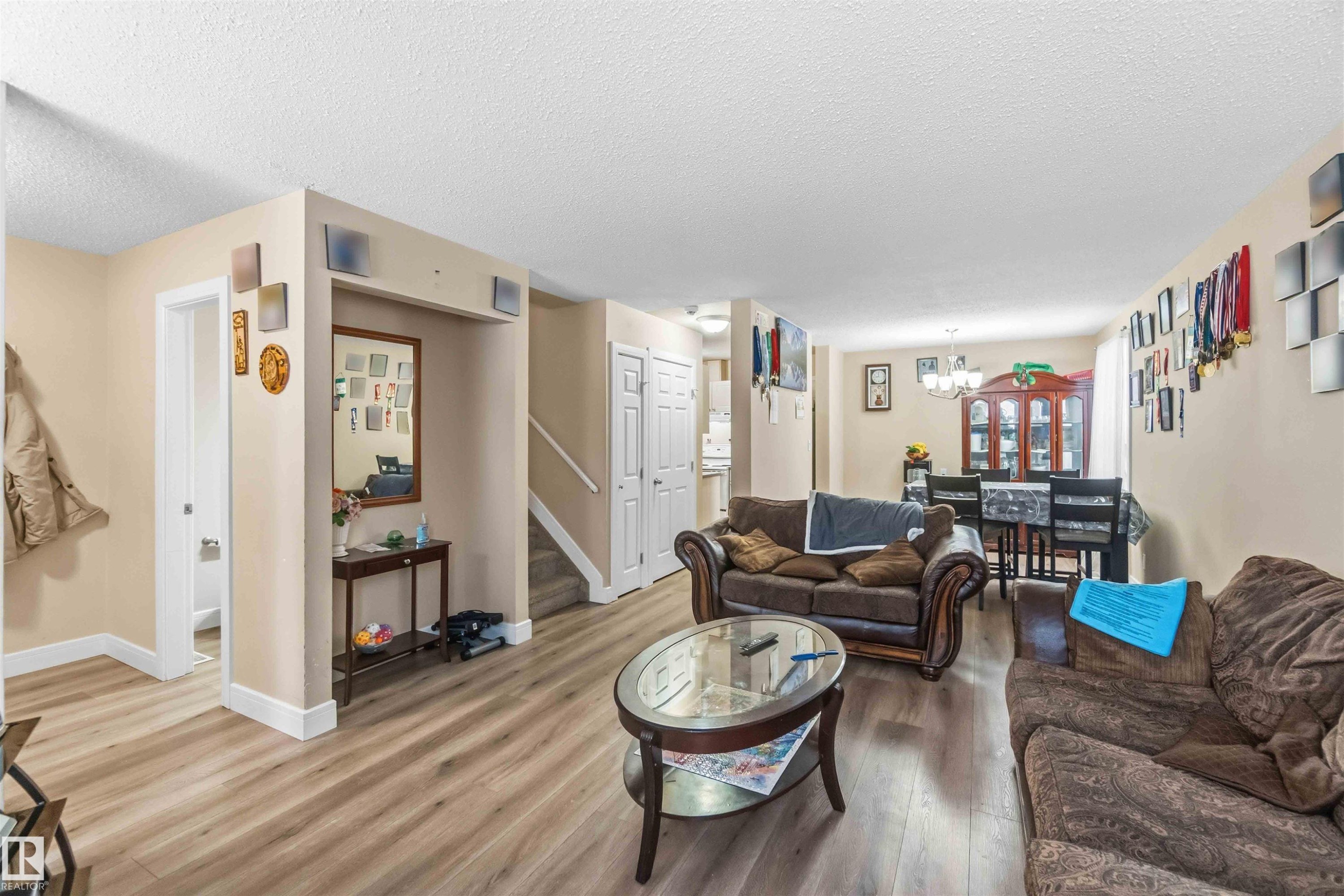 Open-concept living area featuring wood-finish flooring throughout - 17118 108 Street, Edmonton, AB