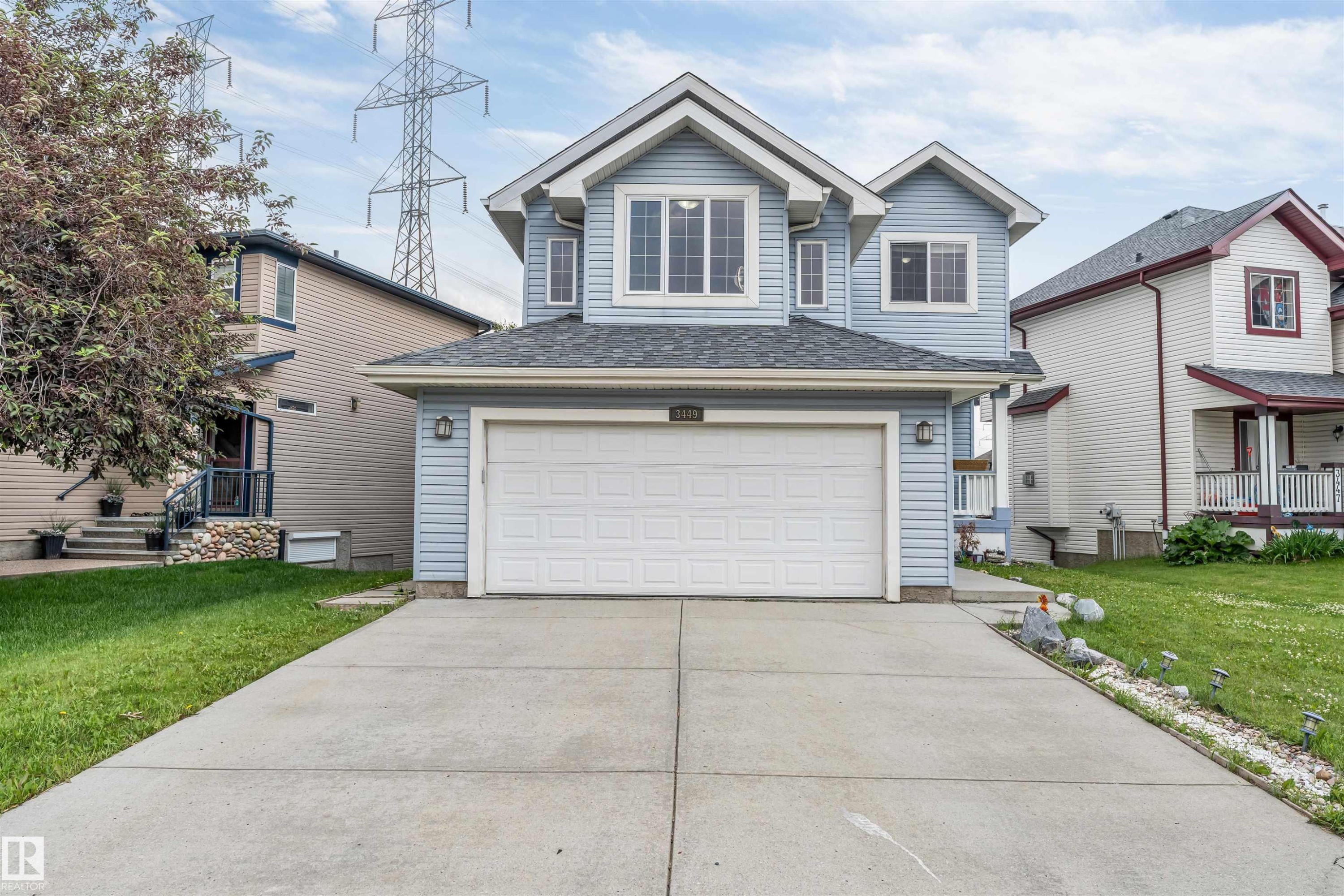 Light blue siding exterior with white trim and a dark shingled roof - 3449 28 Street, Edmonton, AB
