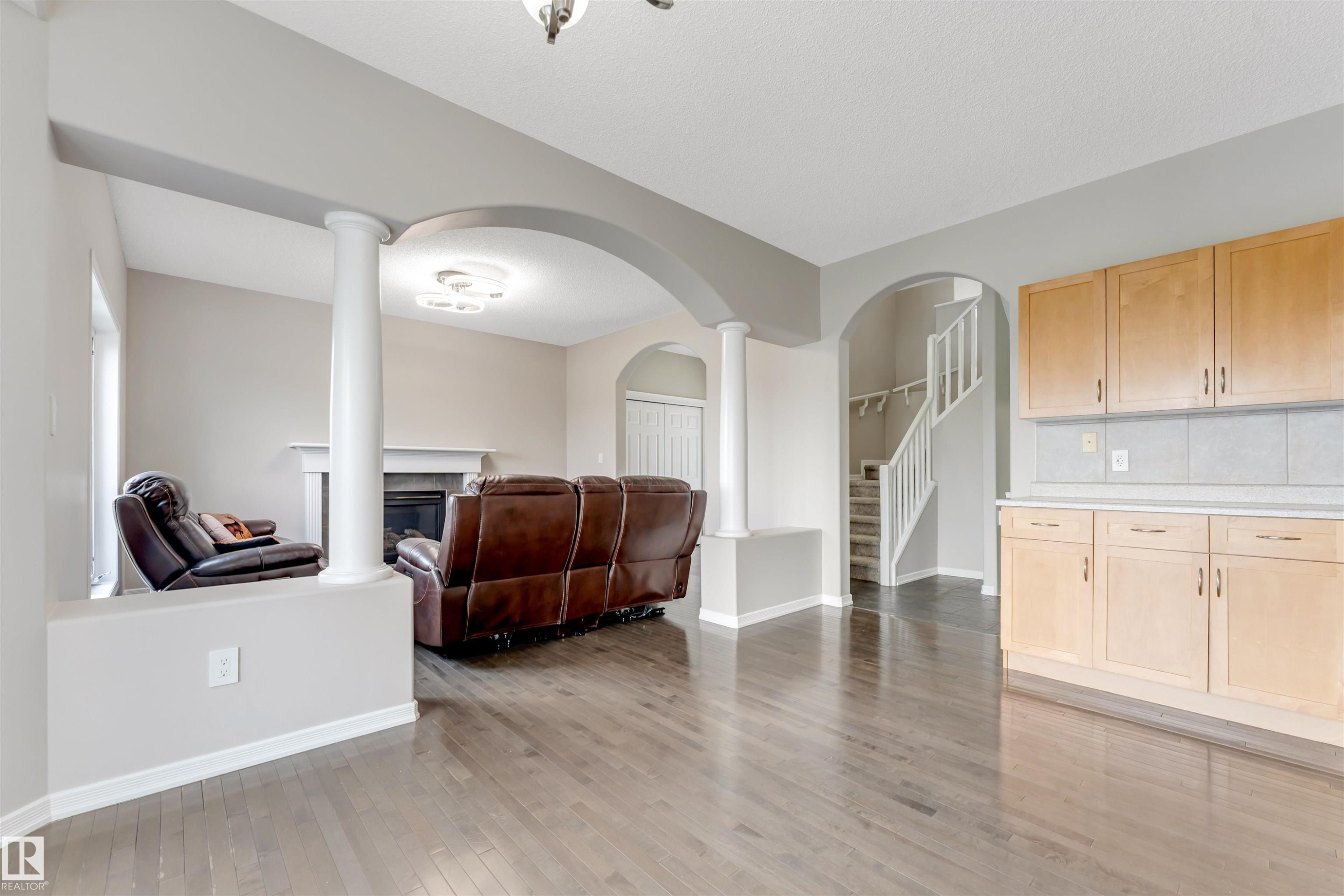 Open-concept living area featuring wood-finish flooring - 3449 28 Street, Edmonton, AB