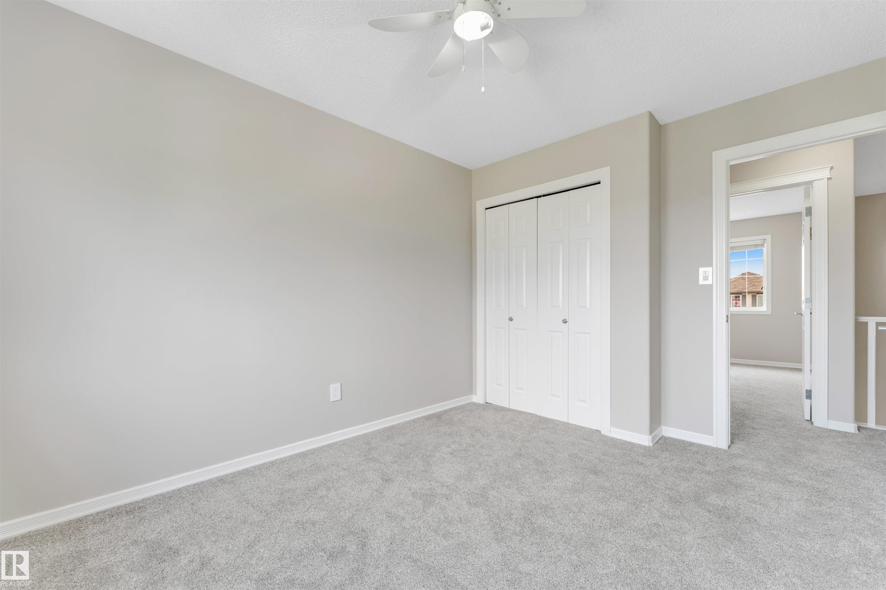 Carpeted interior space with light gray walls and white trim - 3449 28 Street, Edmonton, AB