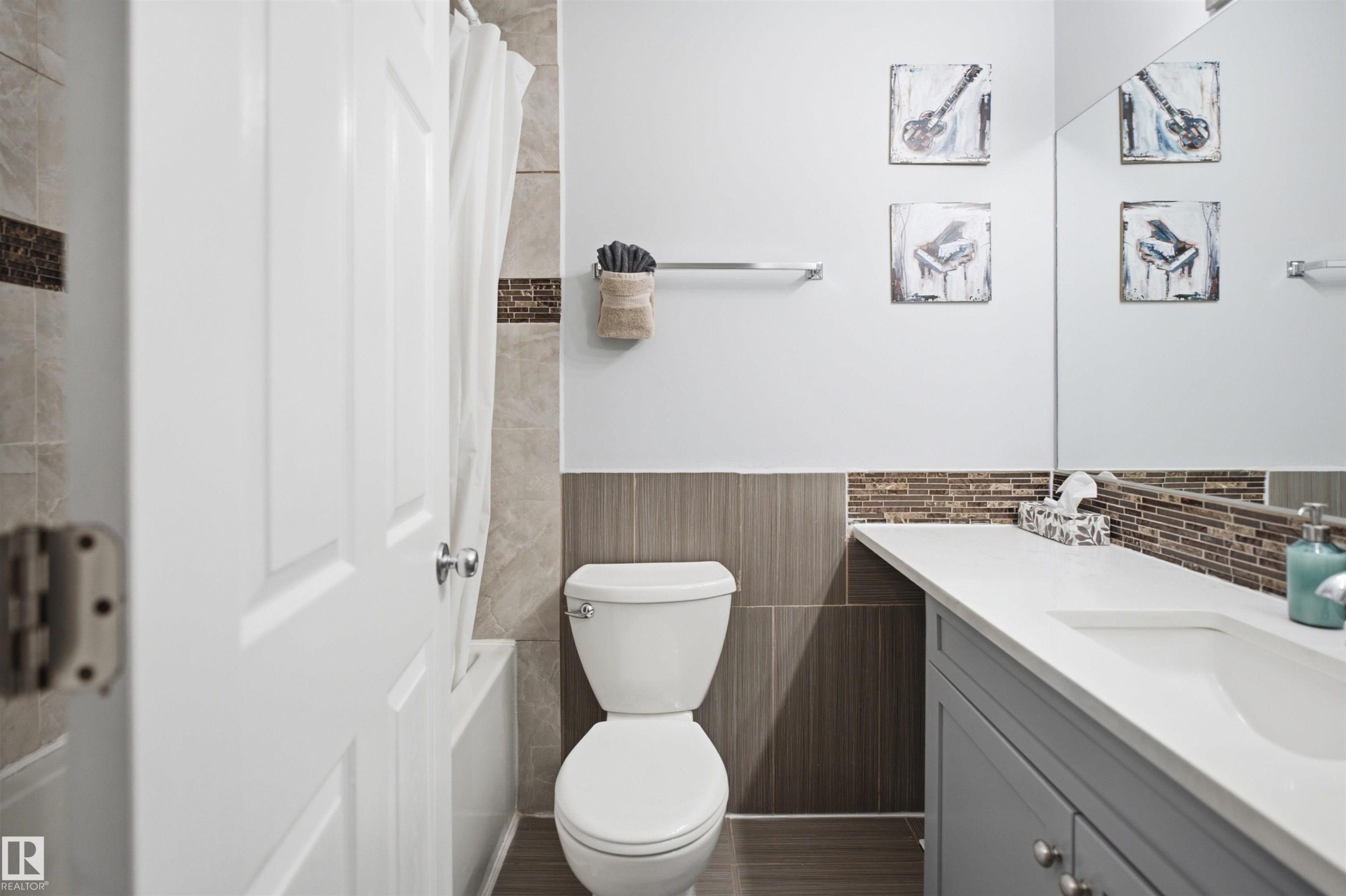 Bathroom featuring a single vanity with a white countertop, under-mount sink, and gray cabinetry - 92 230 Edwards Drive, Edmonton, AB