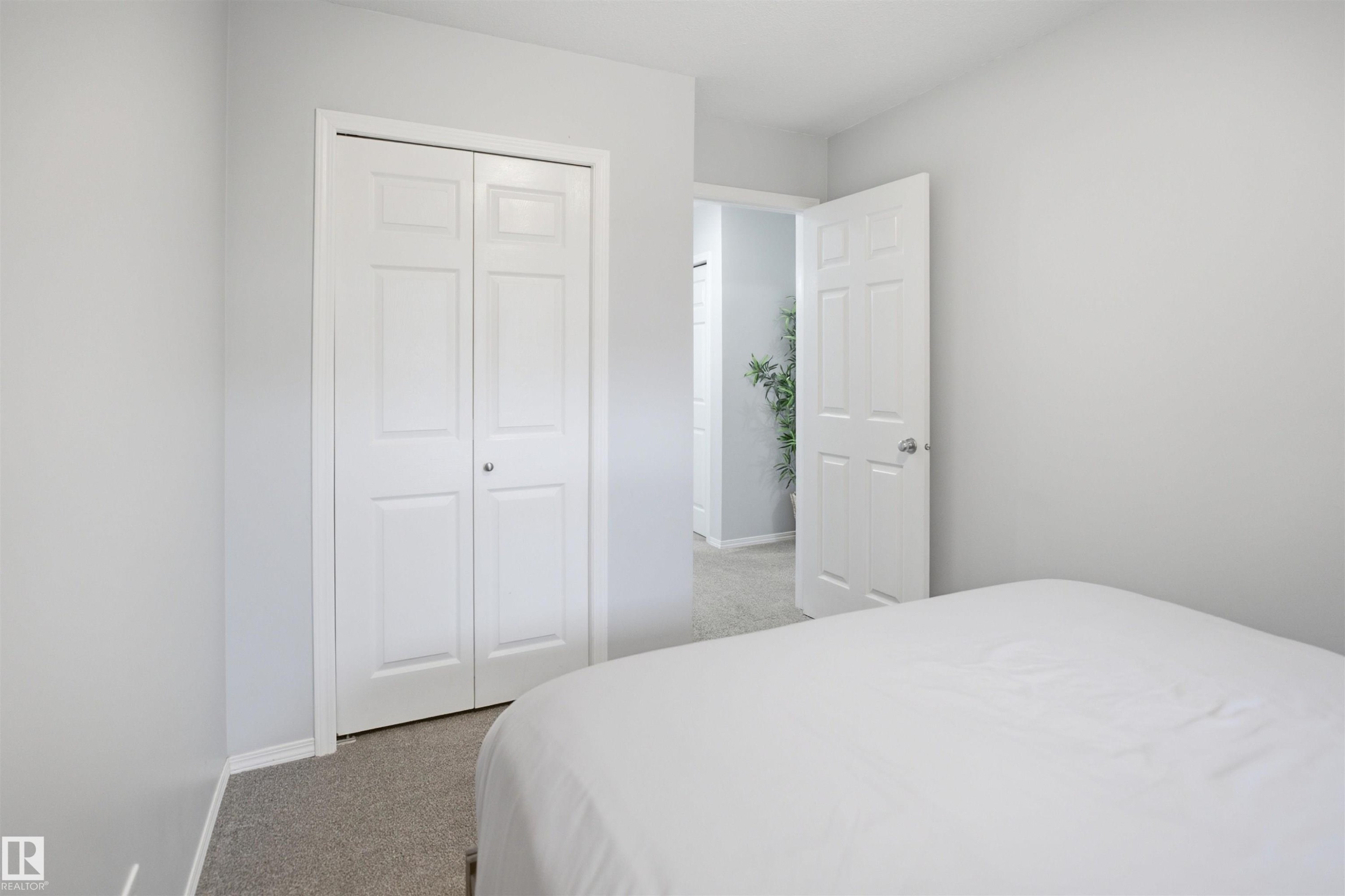 Room featuring light gray walls, white baseboards, and neutral carpet flooring - 92 230 Edwards Drive, Edmonton, AB