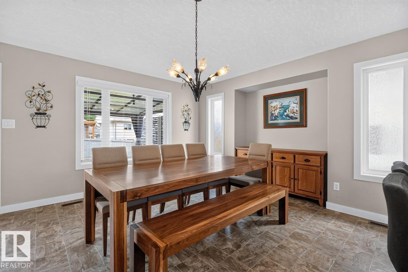 Dining area featuring large window with blinds, recessed wall niche, and durable tile flooring - 448 Ormsby Road Nw, Edmonton, AB - Indoor