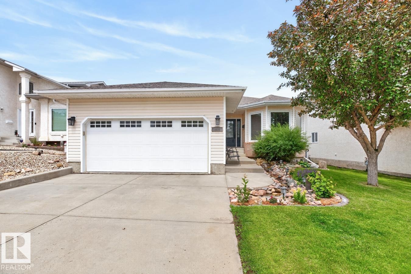 Cream-colored siding exterior with an attached two-car garage - 448 Ormsby Road Nw, Edmonton, AB - Outdoor With Facade