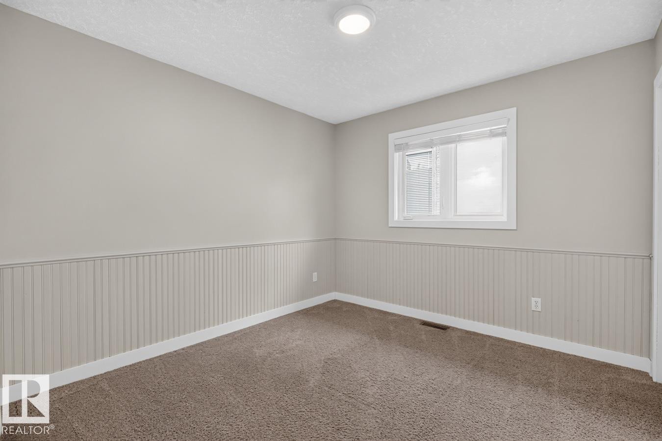 Room featuring neutral painted walls, wainscoting, and carpet flooring - 448 Ormsby Road Nw, Edmonton, AB - Indoor Photo Showing Other Room
