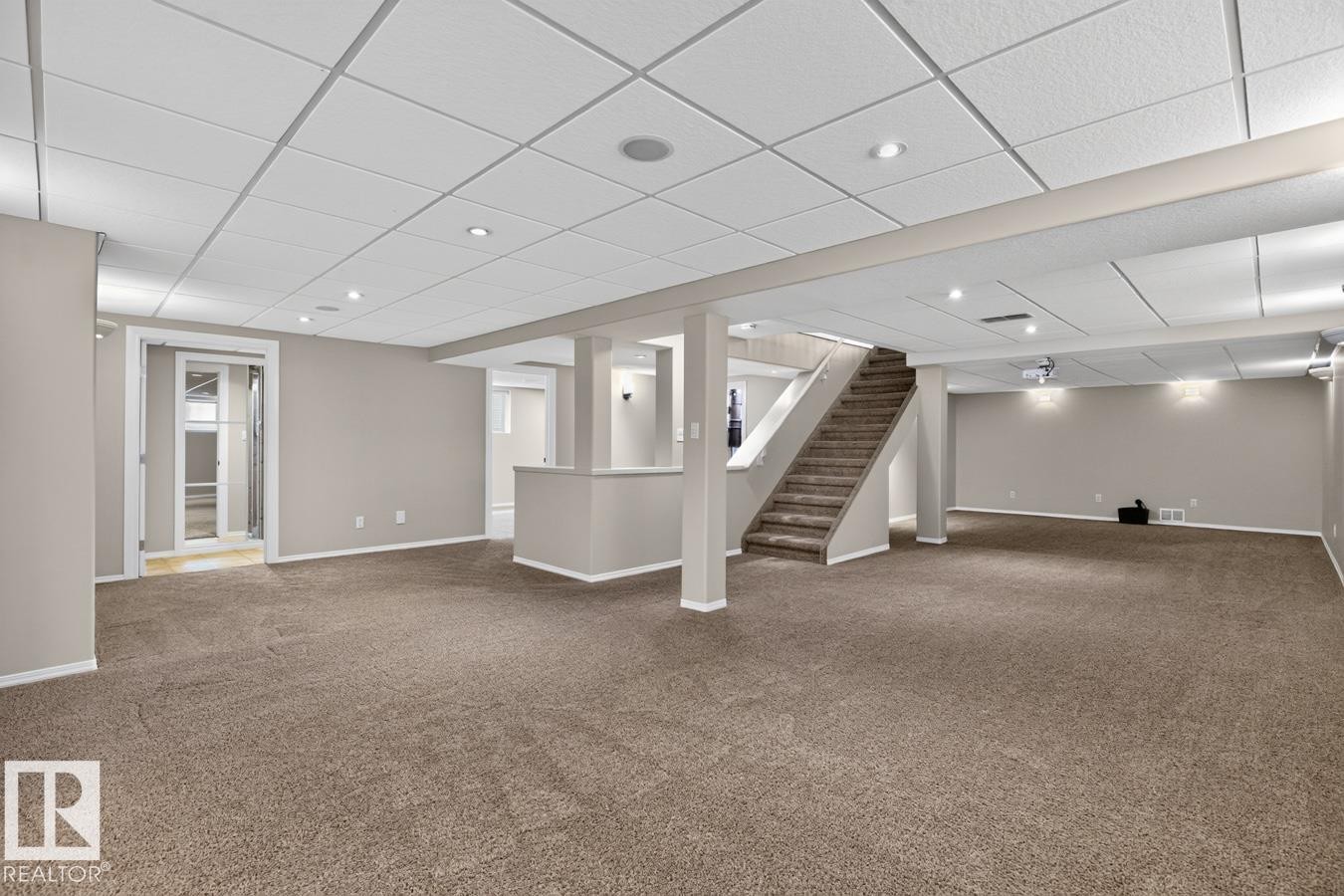 Expansive lower-level space featuring broadloom carpet, recessed lighting, and a drop ceiling - 448 Ormsby Road Nw, Edmonton, AB - Indoor Photo Showing Other Room