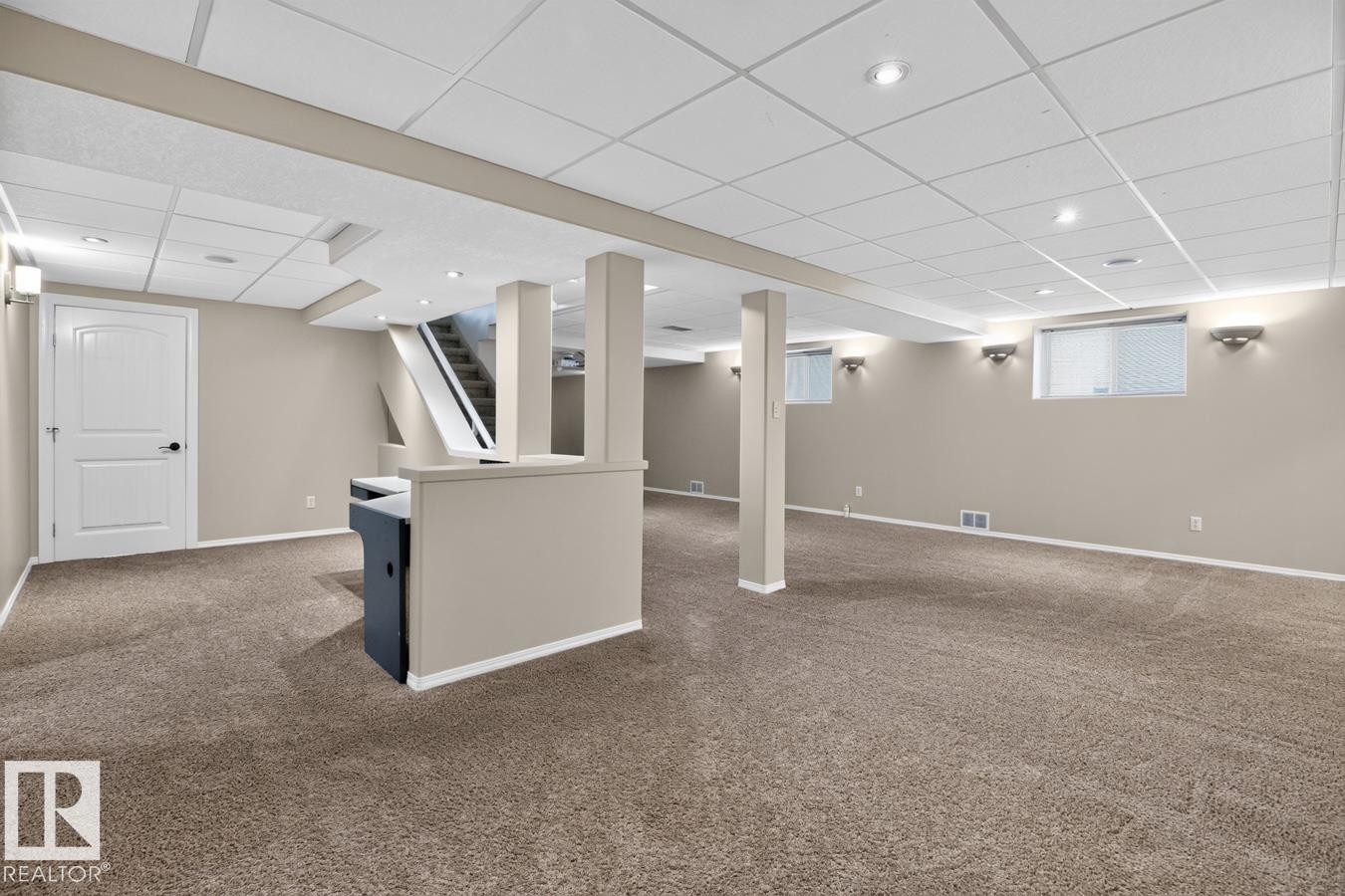 Expansive lower level featuring neutral carpeting, recessed lighting, drop ceiling, white trim, and light-colored walls - 448 Ormsby Road Nw, Edmonton, AB - Indoor