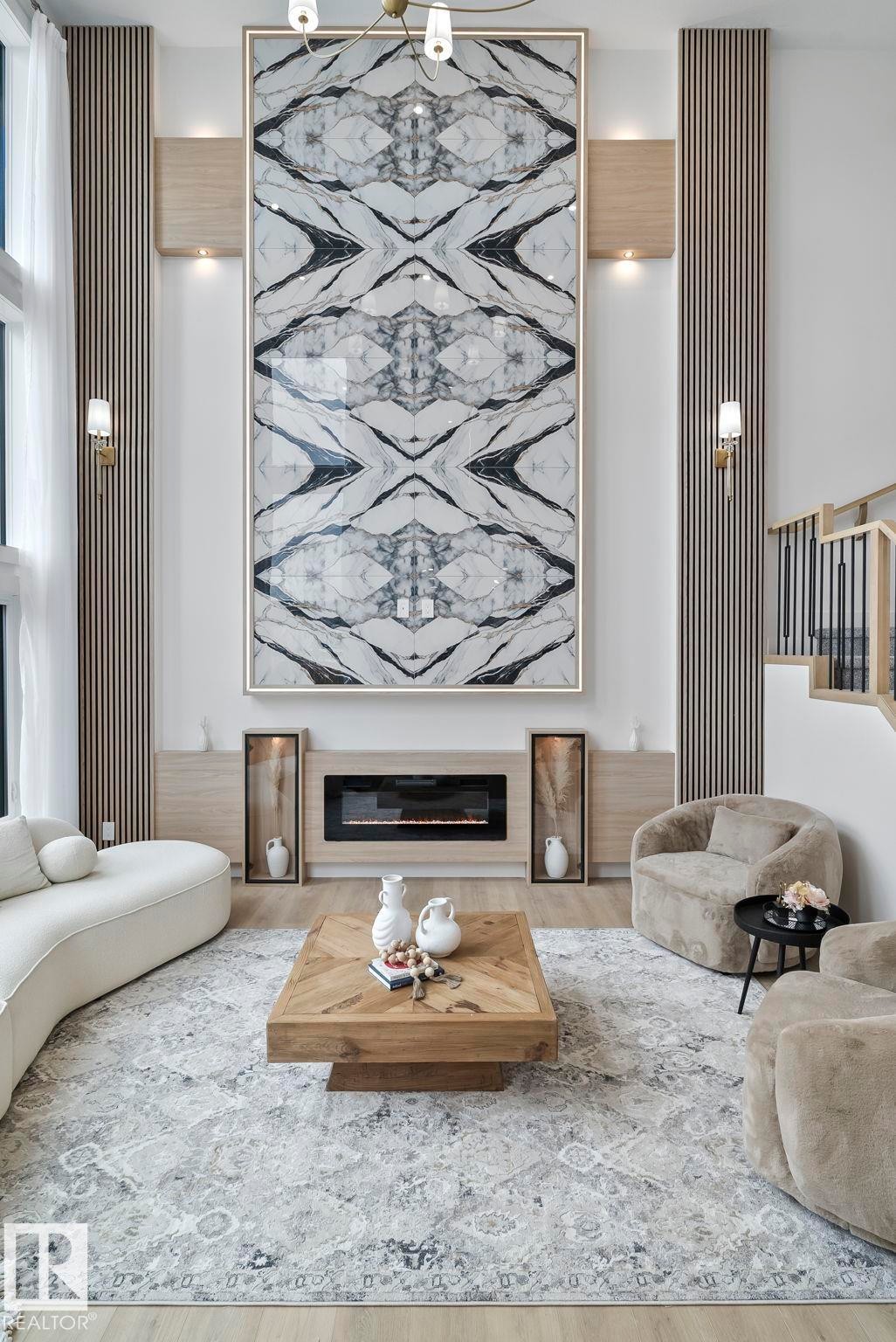Living area featuring a floor-to-ceiling accent wall with a striking marble-patterned panel, integrated electric fireplace, and recessed shelving - 13152 187 Avenue, Edmonton, AB
