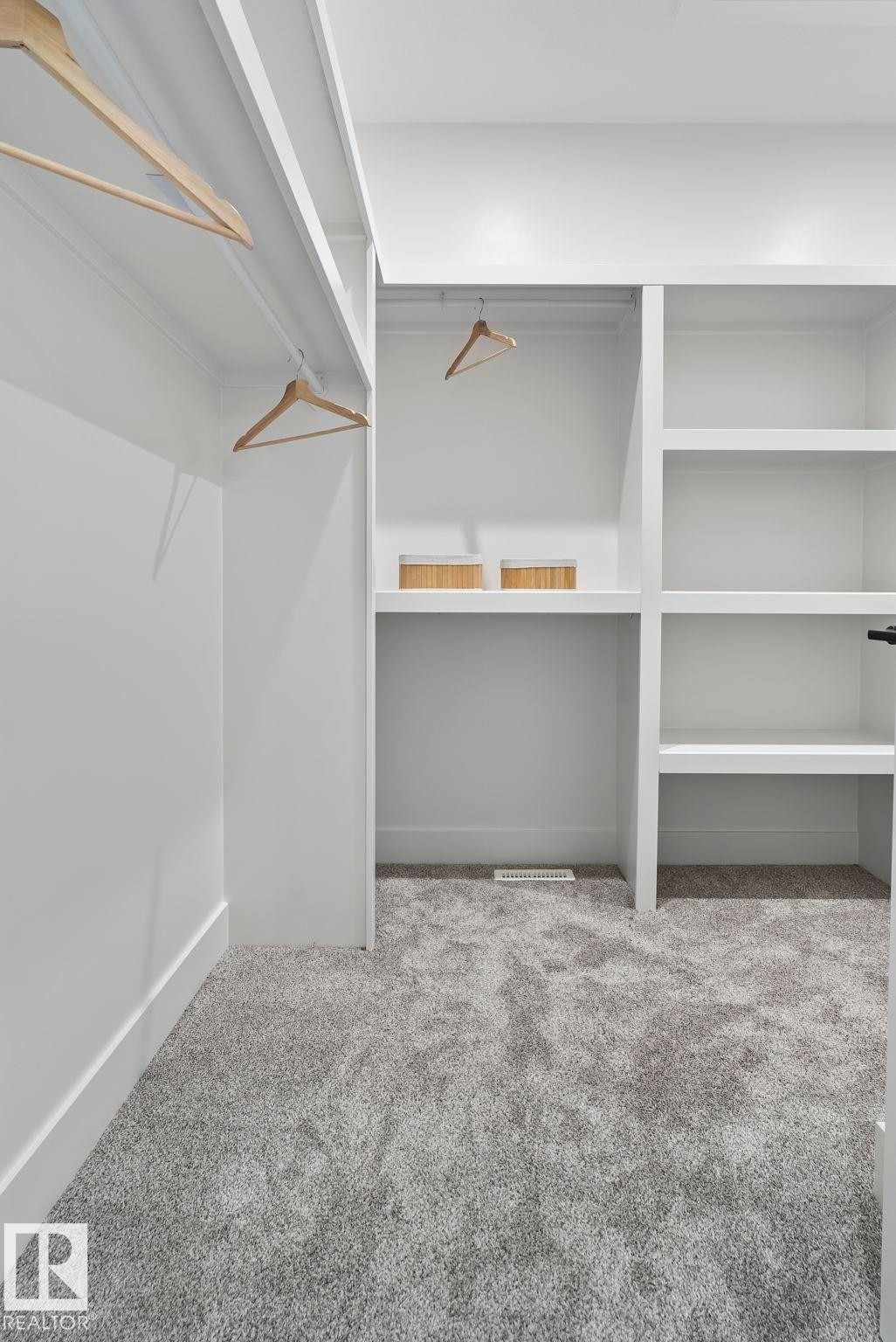 Custom closet system featuring multiple hanging rods and integrated shelving - 13152 187 Avenue, Edmonton, AB