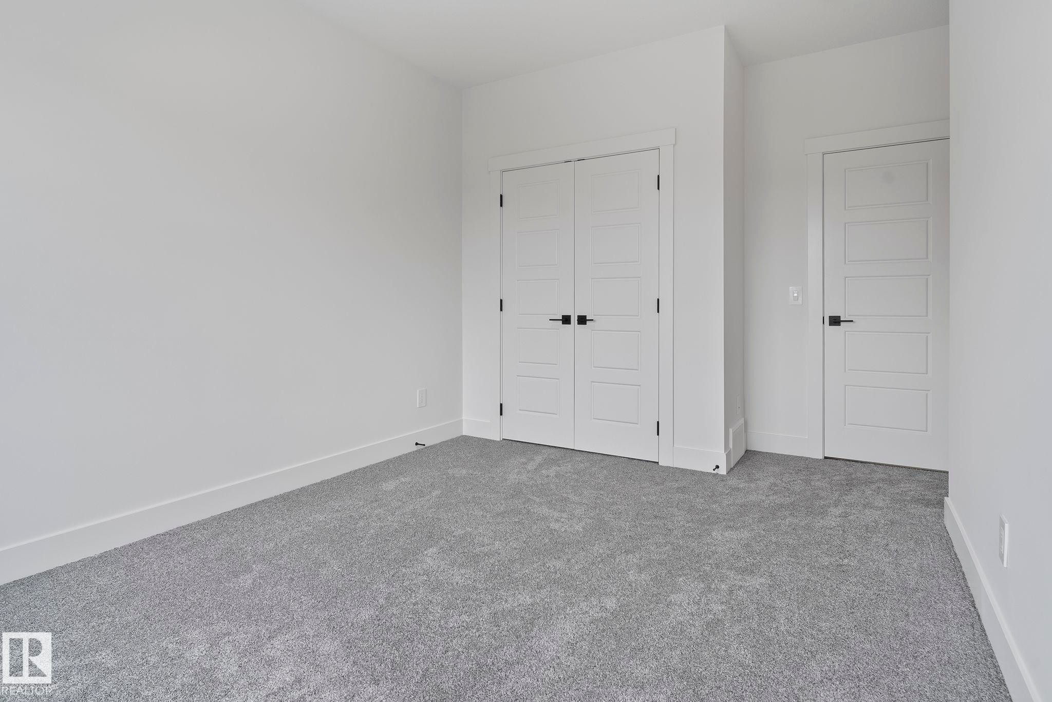 Neutral gray carpet flooring complementing bright white walls - 13152 187 Avenue, Edmonton, AB