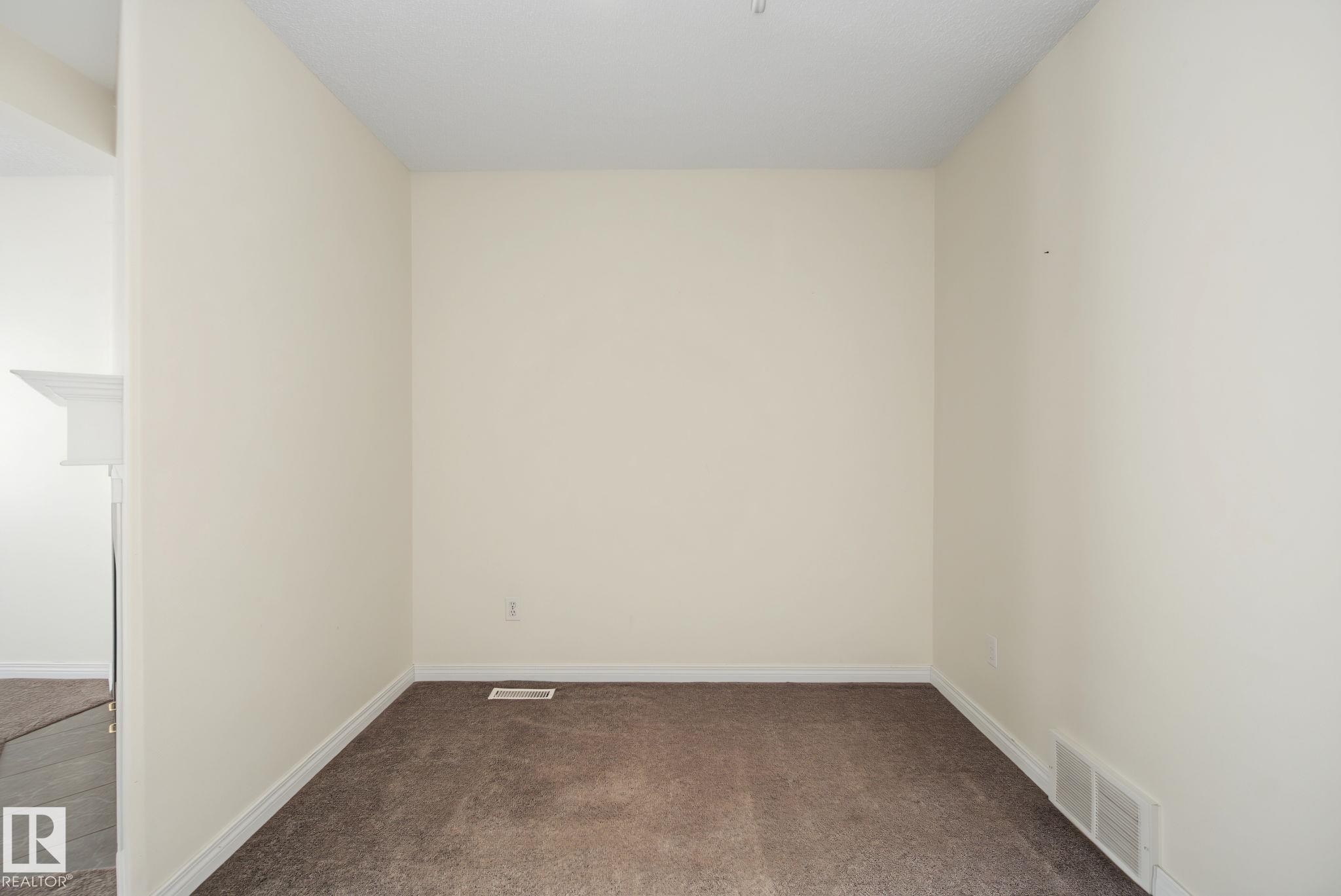 Carpeted interior space with neutral wall tones and white baseboard trim - 4259 29 Avenue, Edmonton, AB