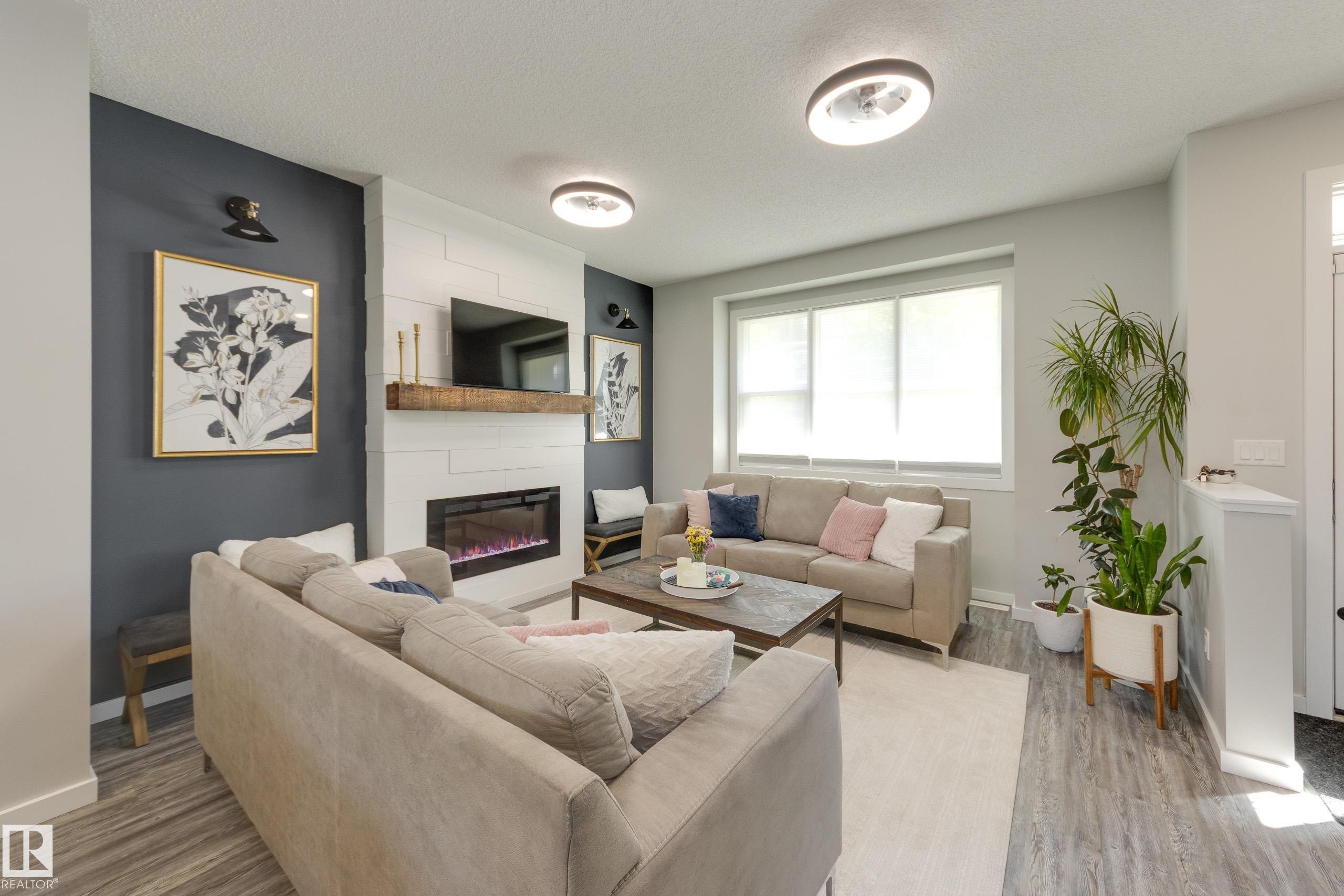 1192 Rosenthal Boulevard Nw, Edmonton, AB - Indoor Photo Showing Living Room With Fireplace