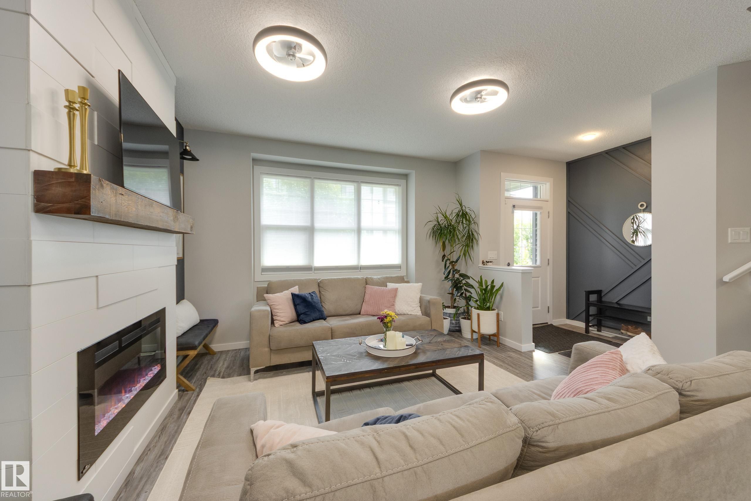 1192 Rosenthal Boulevard Nw, Edmonton, AB - Indoor Photo Showing Living Room With Fireplace
