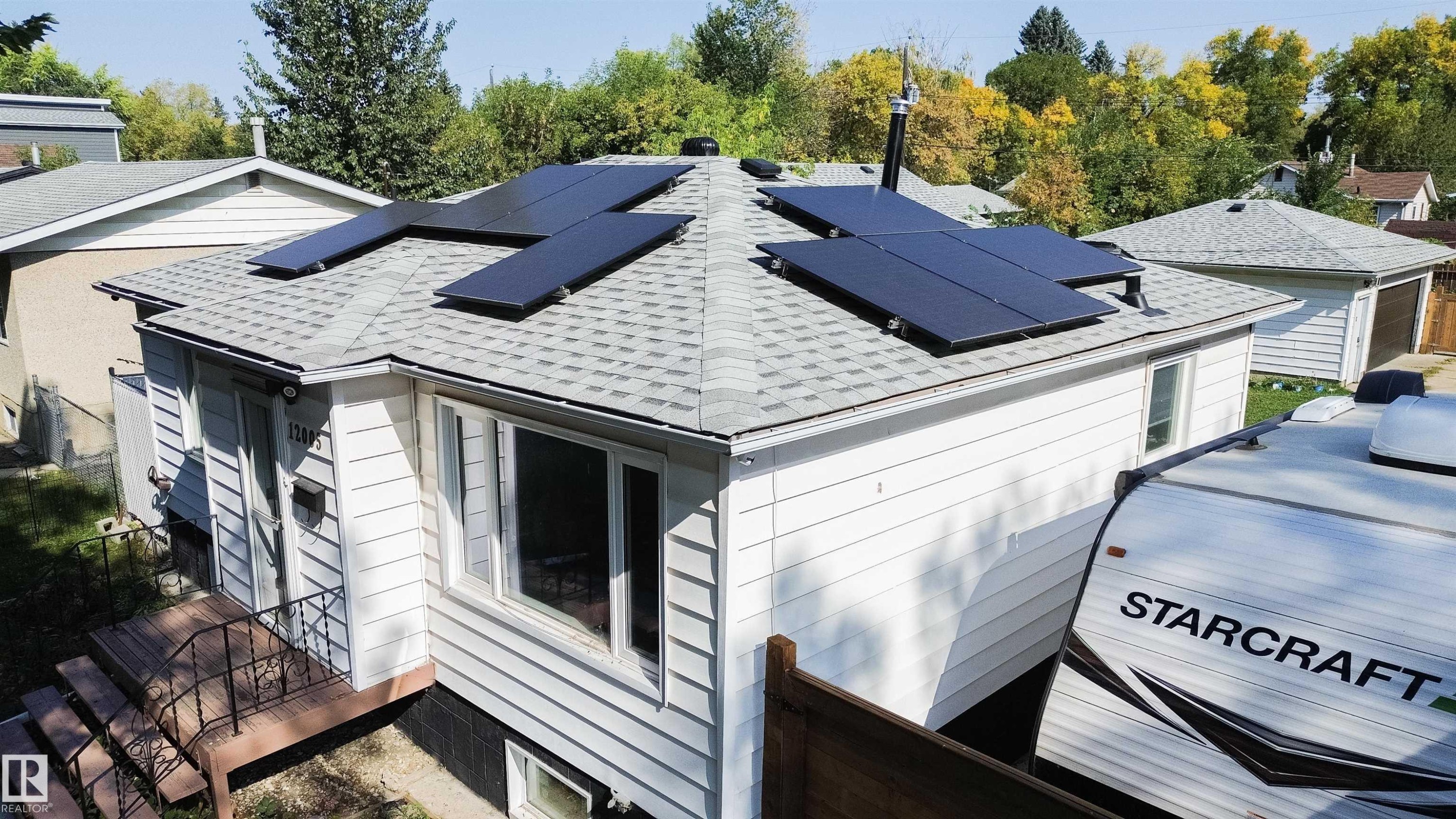 Exterior residence featuring a gabled roof with solar panel installation - 12005 40 St Nw, Edmonton, AB - Outdoor
