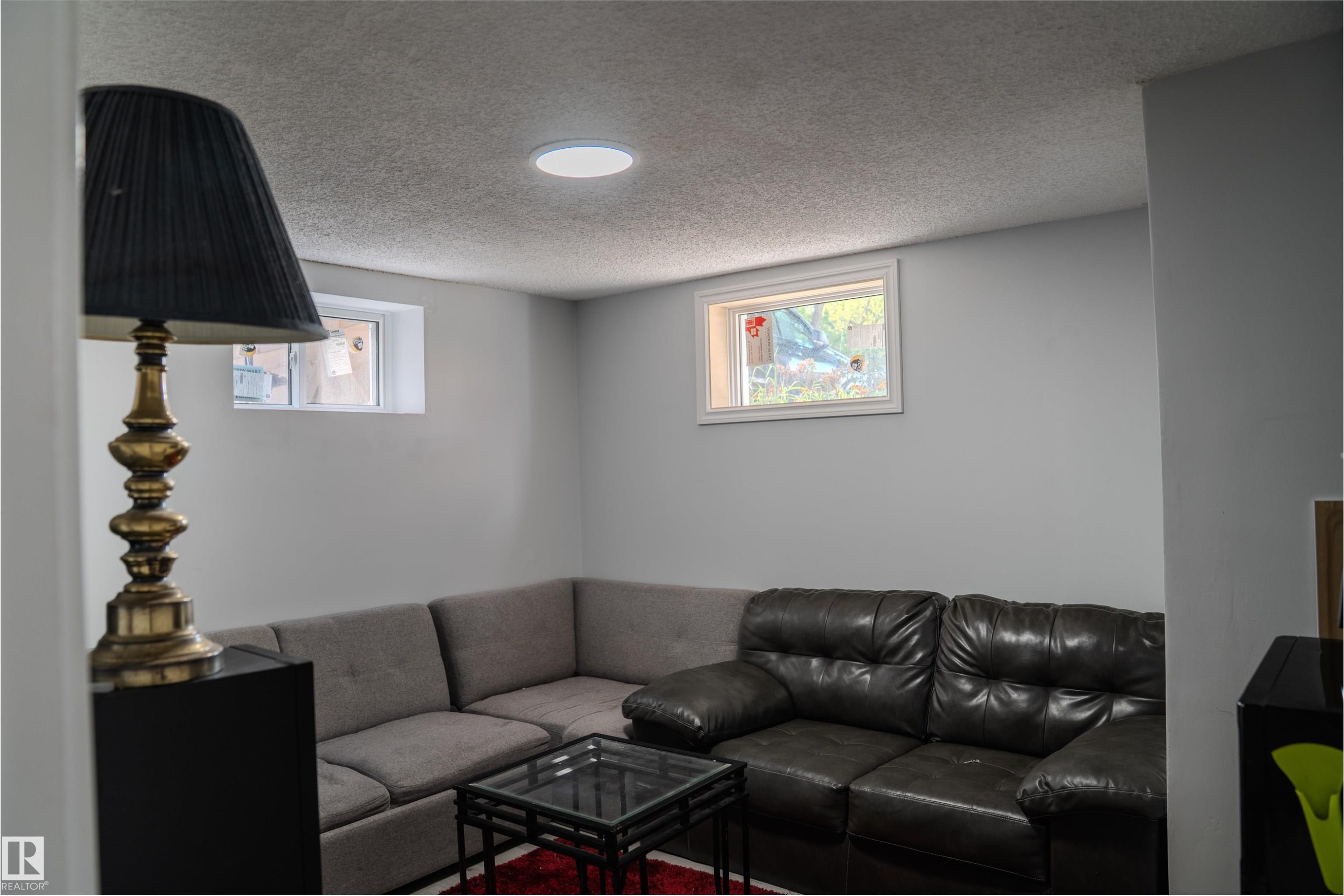 Neutral wall tones complement the bright ceiling light - 12005 40 St Nw, Edmonton, AB - Indoor Photo Showing Living Room