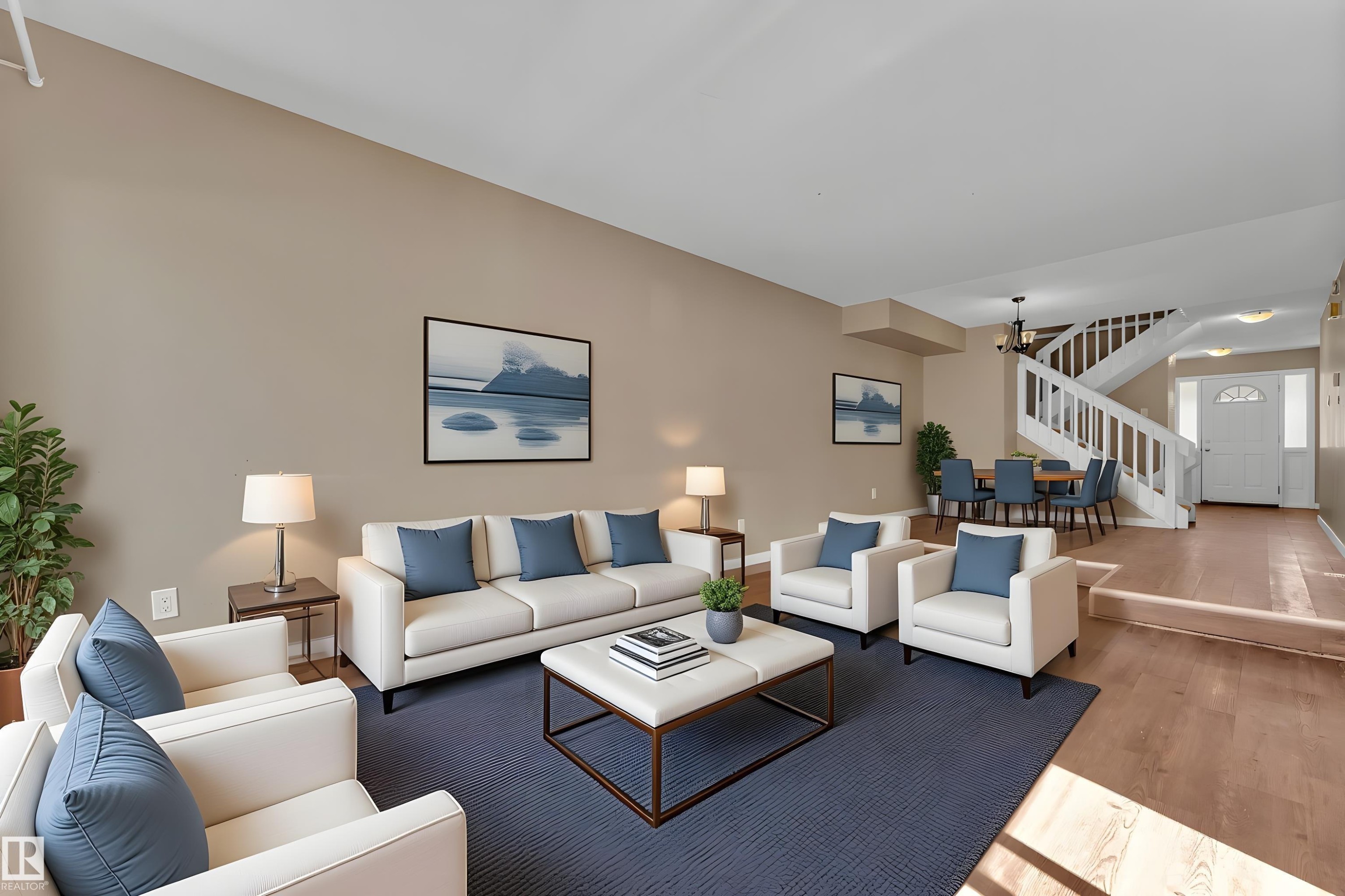Living area featuring a spacious layout, wood-finish flooring, and neutral wall tones - 6632 36A Avenue, Edmonton, AB
