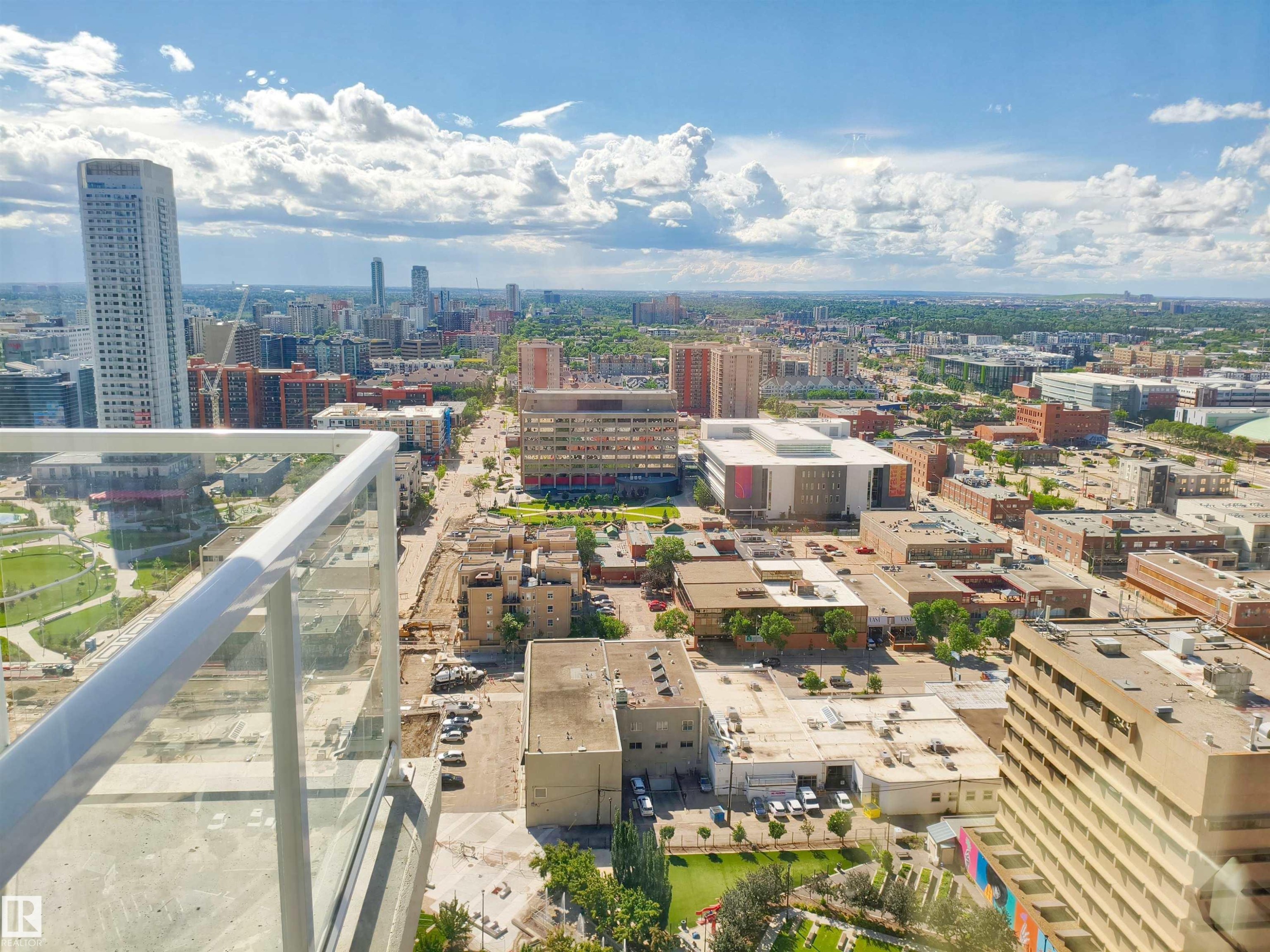 Expansive urban landscape featuring a city skyline, diverse architectural styles, and distant green spaces - #2505 10410 102 Av Nw, Edmonton, AB - Outdoor With View