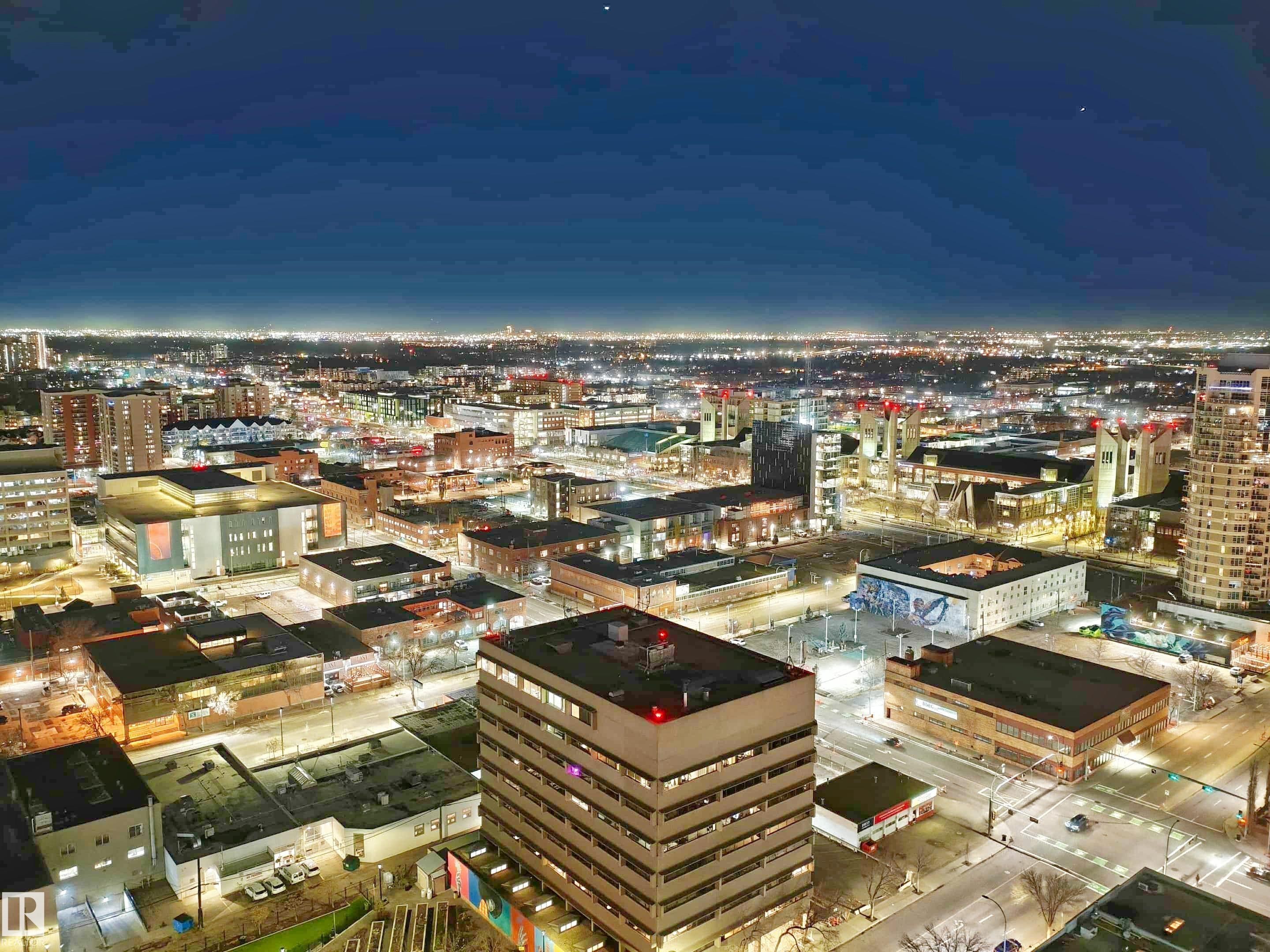 Cityscape with illuminated buildings and expansive urban development - #2505 10410 102 Av Nw, Edmonton, AB - Outdoor With View